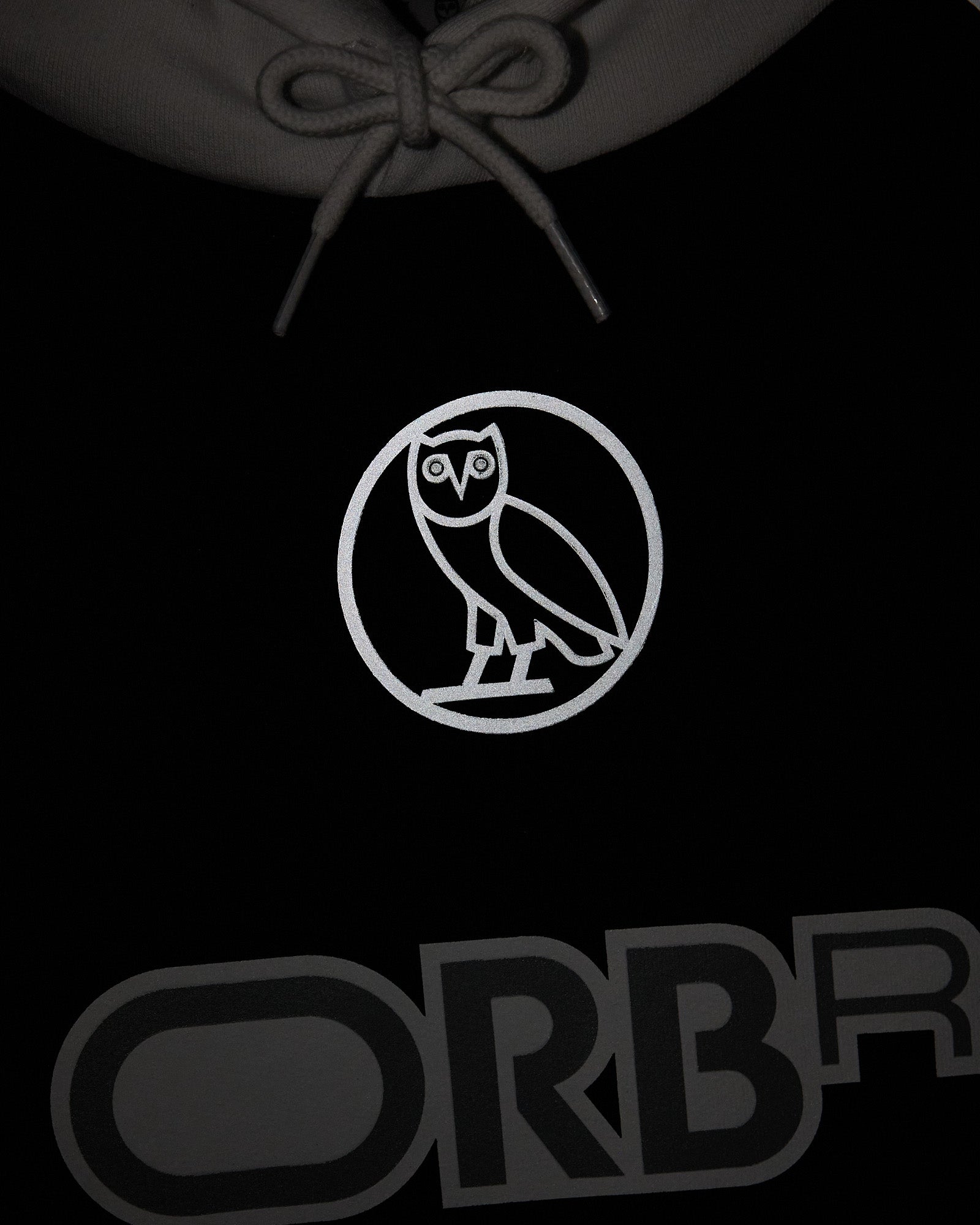 Navy hoodie with gray drawstring, white owl emblem in circle on chest, and gray ORB text at bottom.