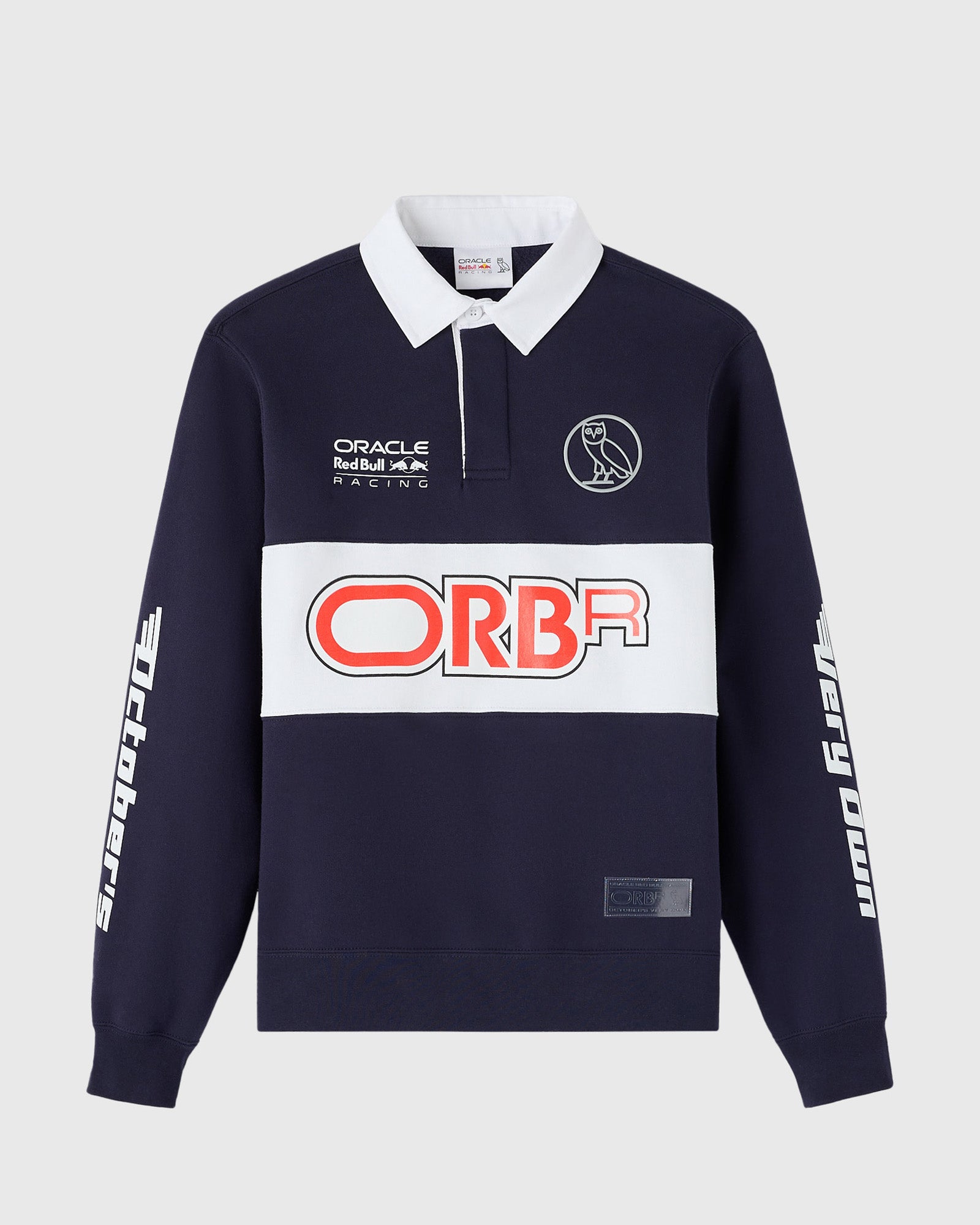 Navy fleece rugby shirt with white collar, Oracle Red Bull Racing and ORBA branding, owl logo, and white sleeve graphics.
