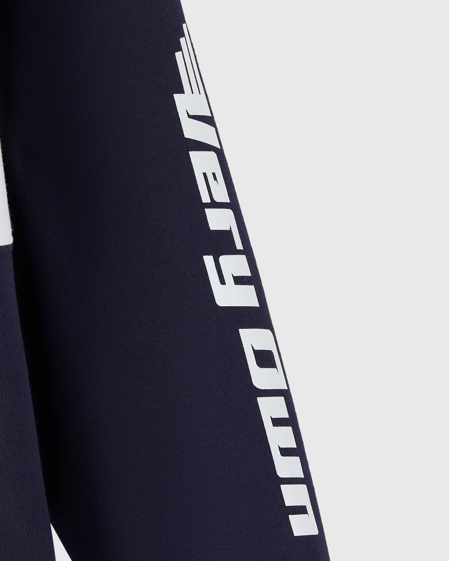 Navy fleece rugby with white "Red Bull Racing" text running vertically down the sleeve.