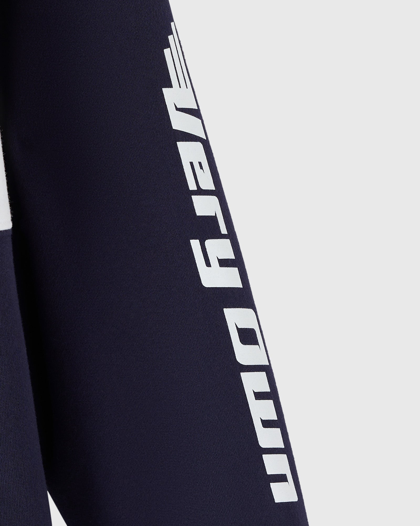 Navy fleece rugby with white "Red Bull Racing" text running vertically down the sleeve.