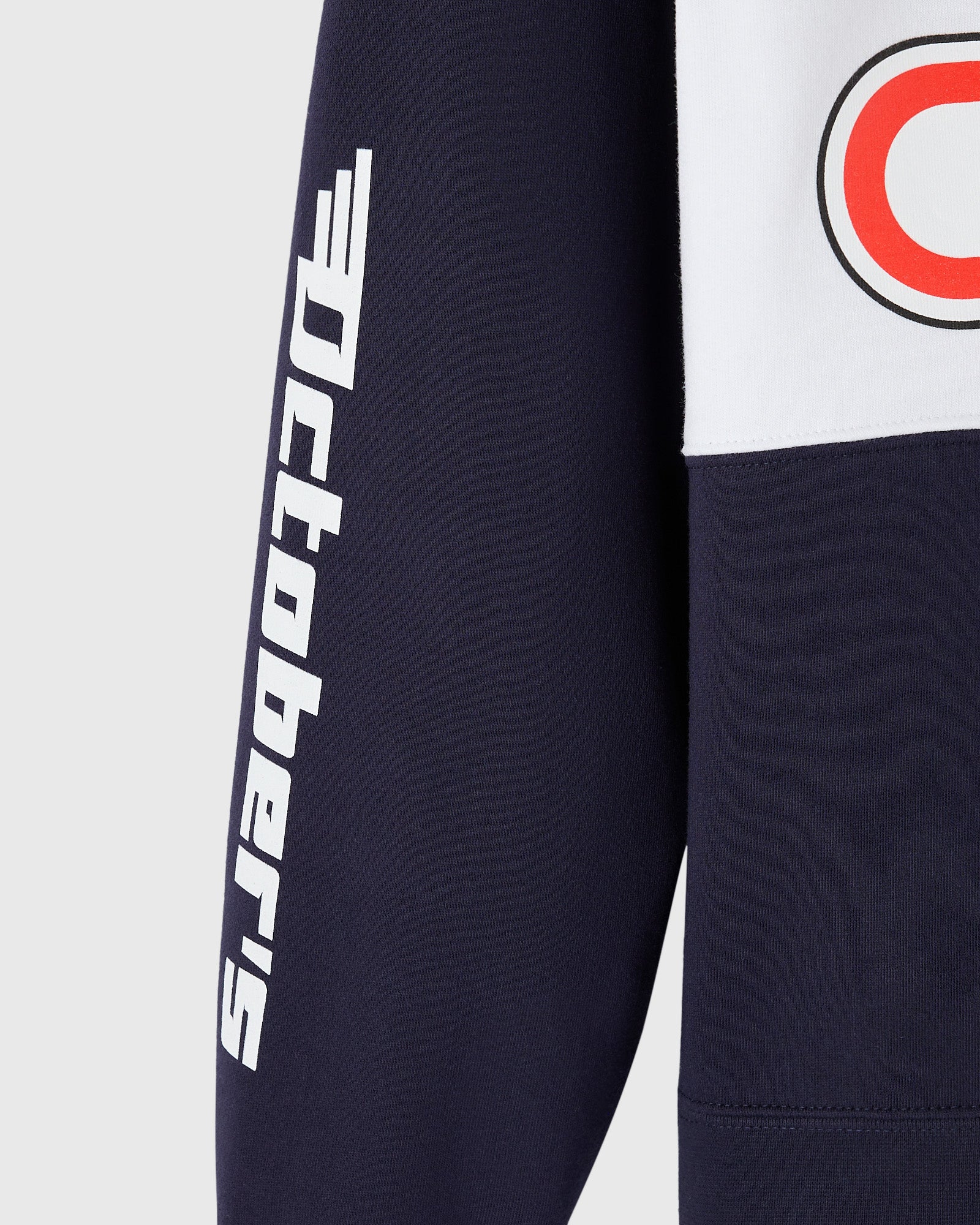 Navy fleece rugby with white "Red Bull" text on sleeve and red circular logo on chest.