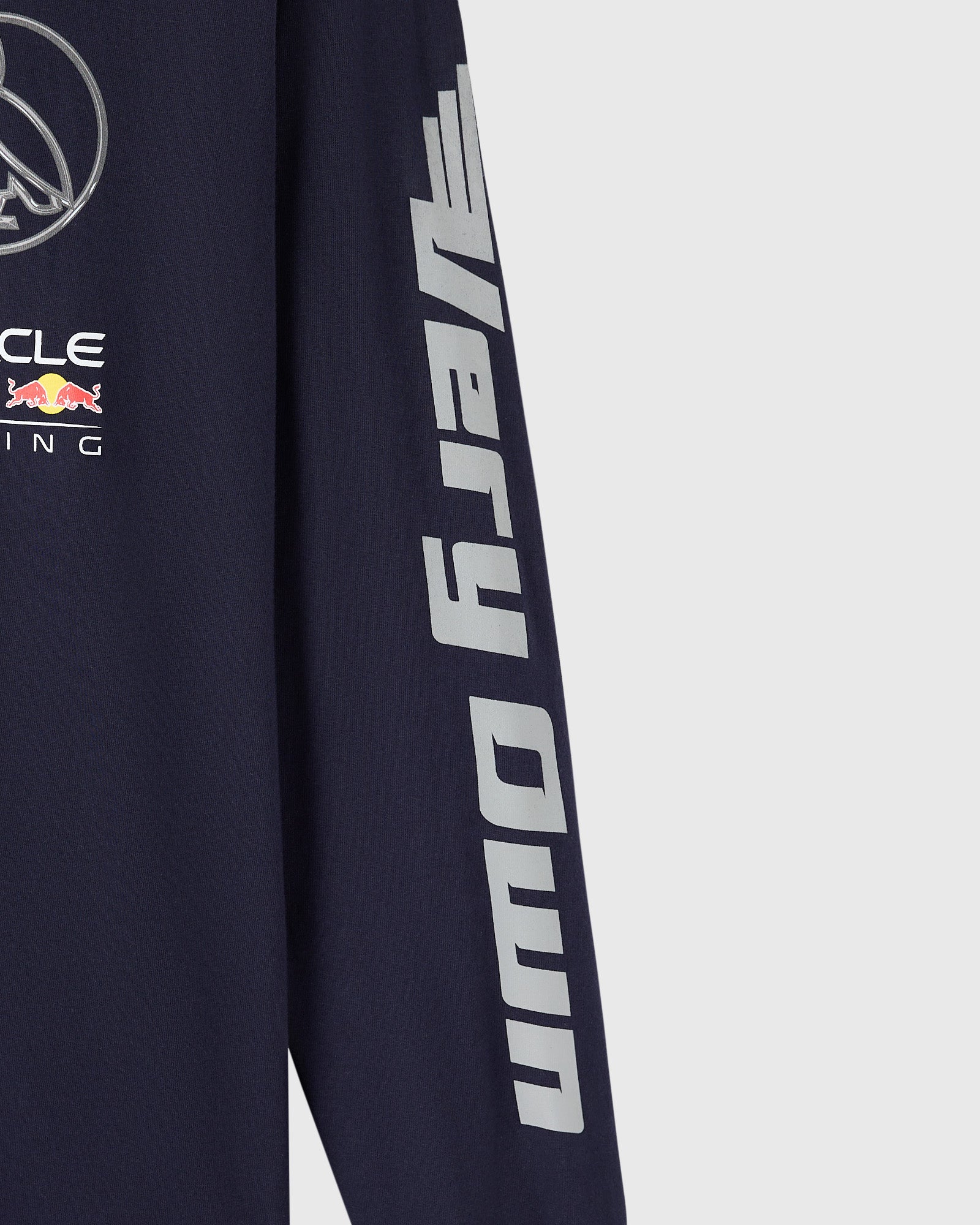 Navy long-sleeve tee with Red Bull Racing branding and gray text down the sleeve.