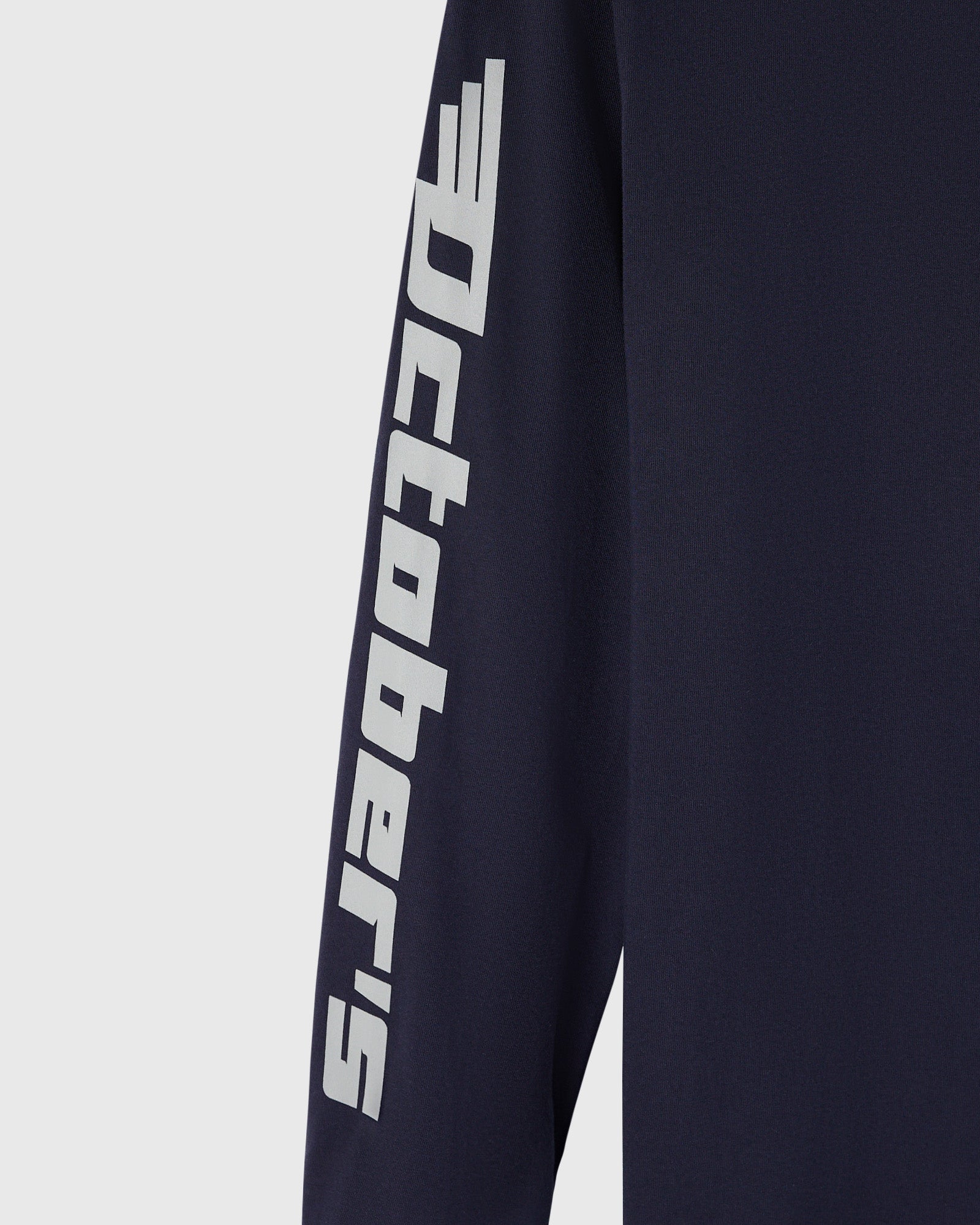 Navy long-sleeve tee with white Red Bull Racing logo and text printed down the sleeve.