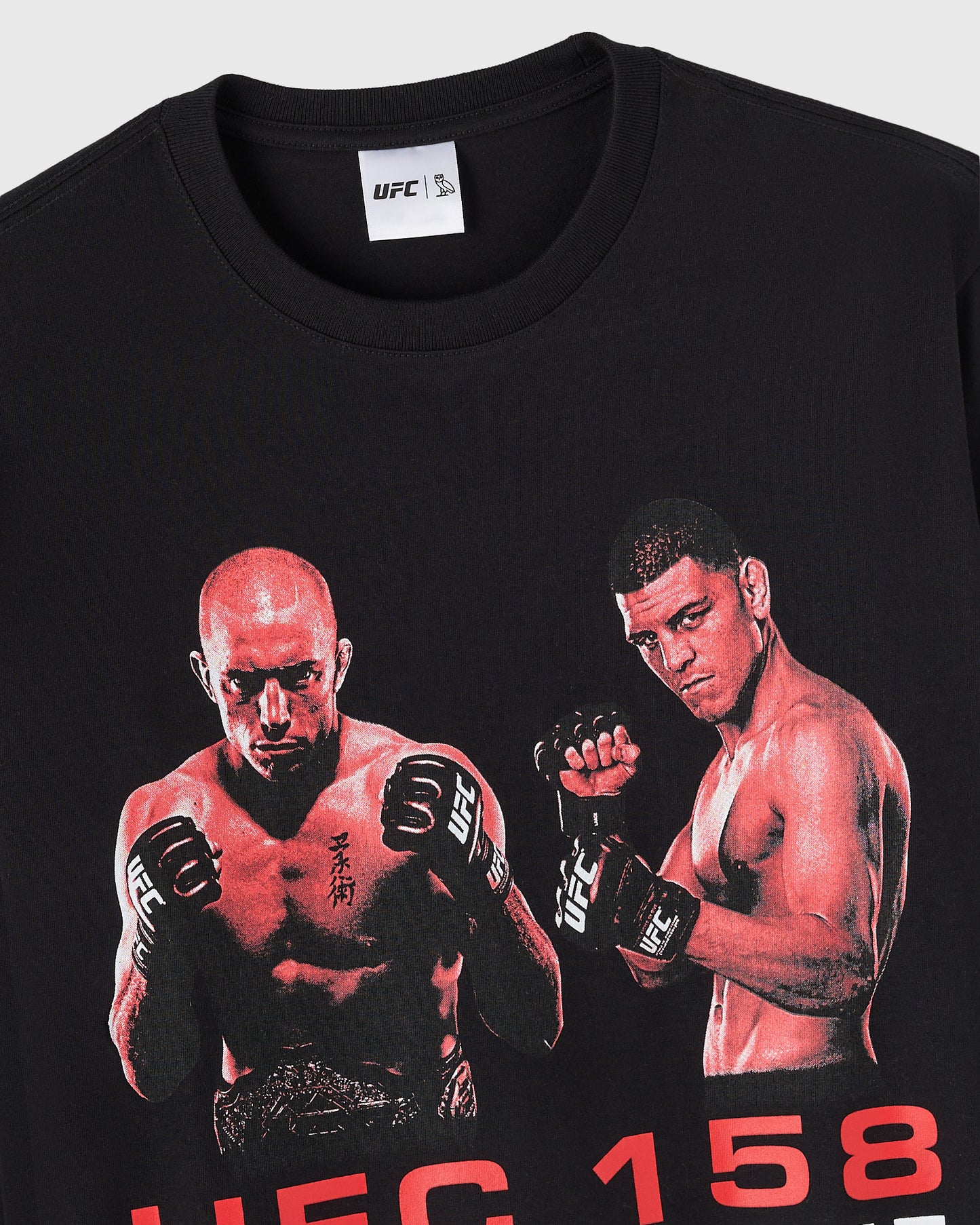 Close up of black long-sleeve tee with UFC GSP vs Diaz graphic featuring two fighters in fighting stance and red text 