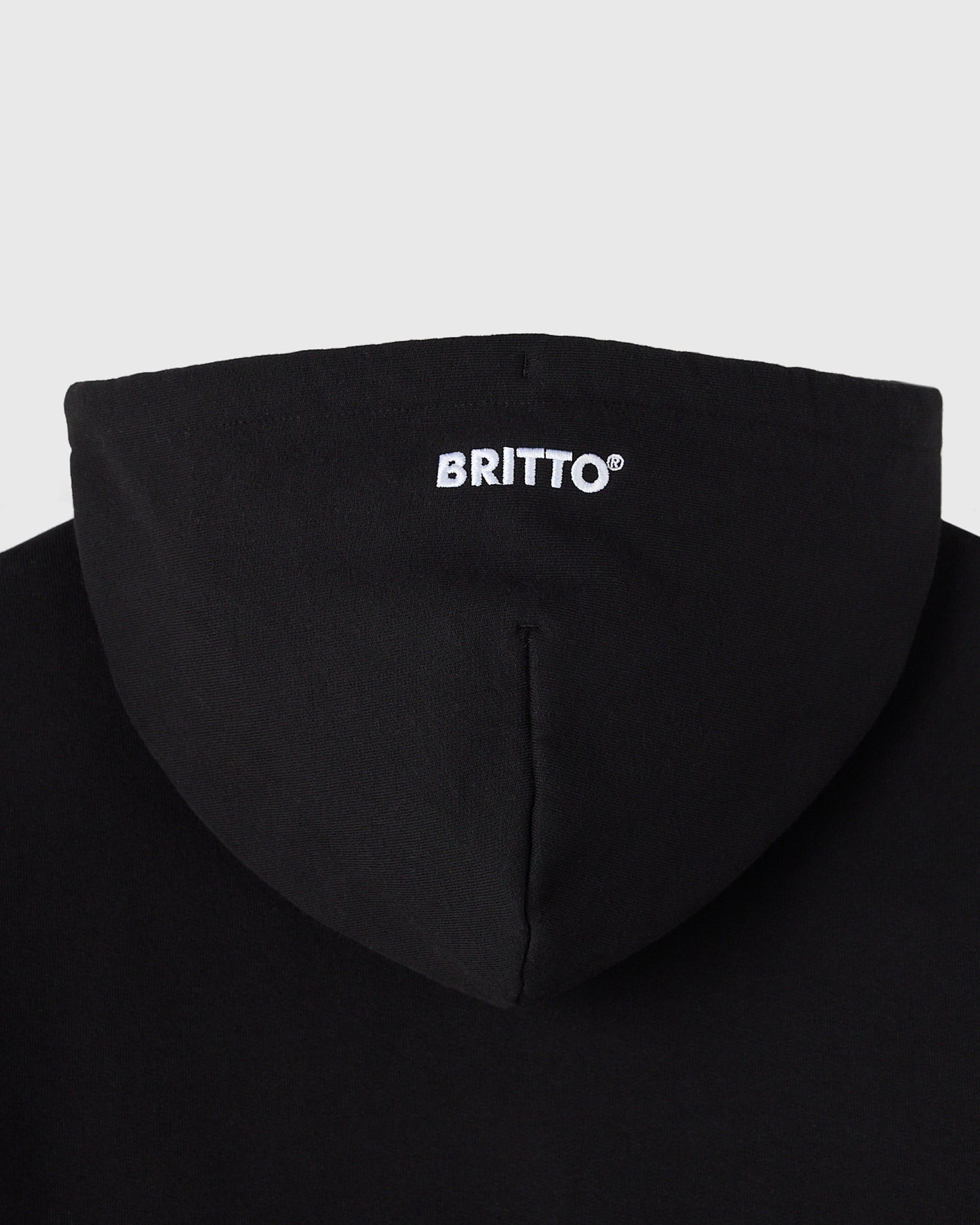 Black hoodie with "BRITTO" text printed on chest and drawstring hood detail visible.