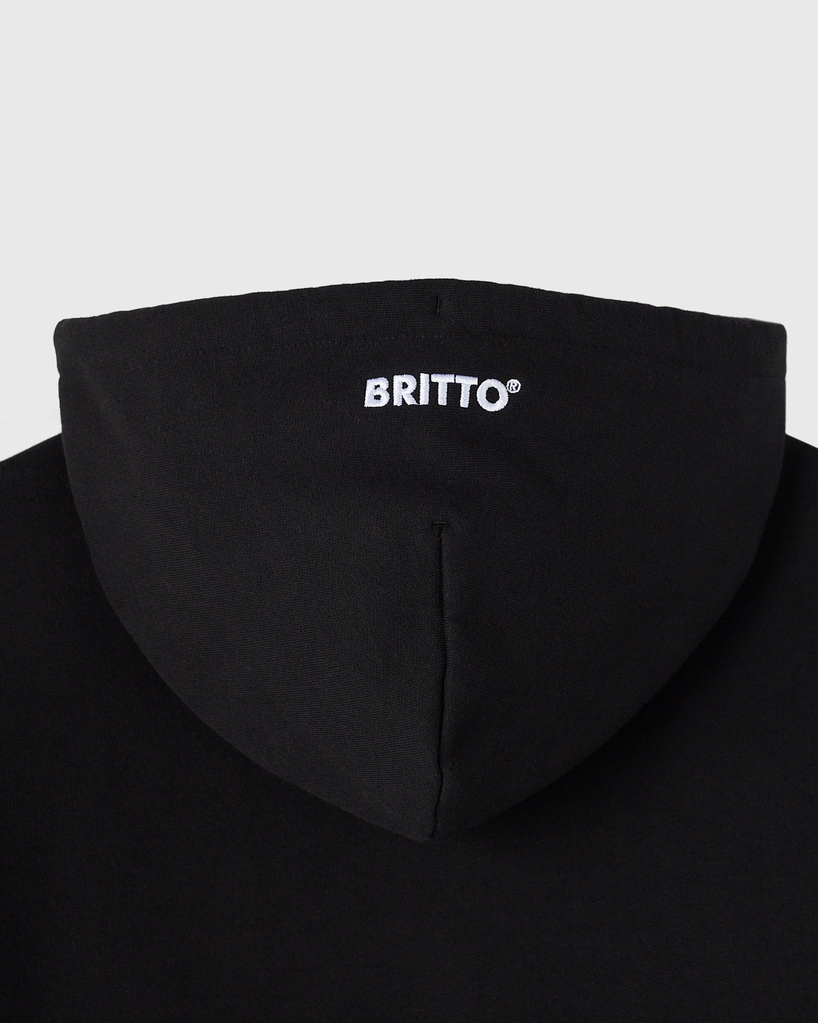Black hoodie with "BRITTO" text printed on chest and drawstring hood detail visible.