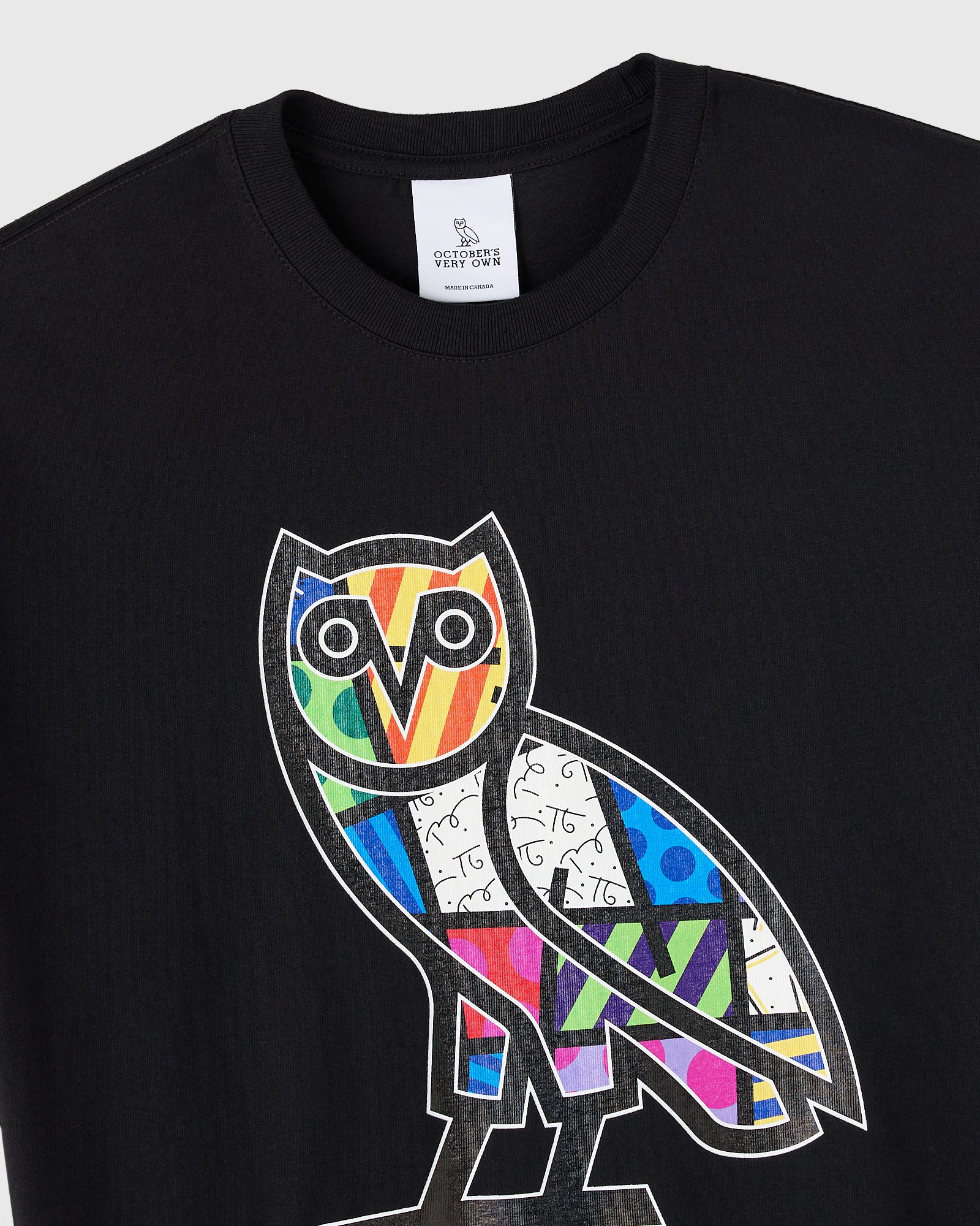 Black crewneck t-shirt with colorful geometric owl graphic on chest featuring multicolored pattern sections.