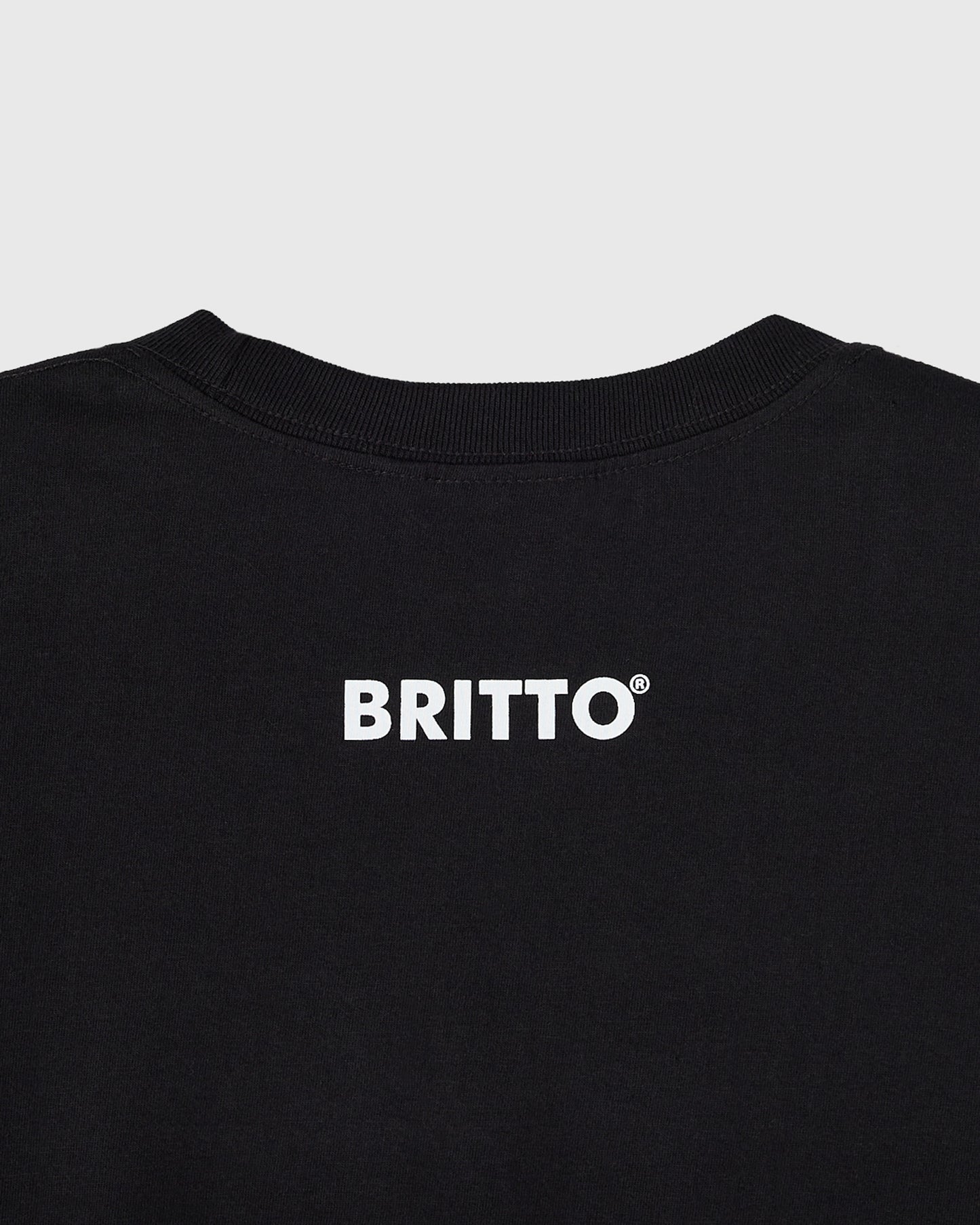 Black t-shirt with white "BRITTO" text and registered trademark symbol on chest.