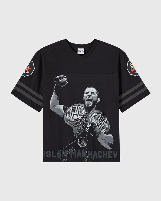 Black short-sleeve tee with UFC fighter Islam Makhachev graphic, striped sleeves, and shoulder patches.