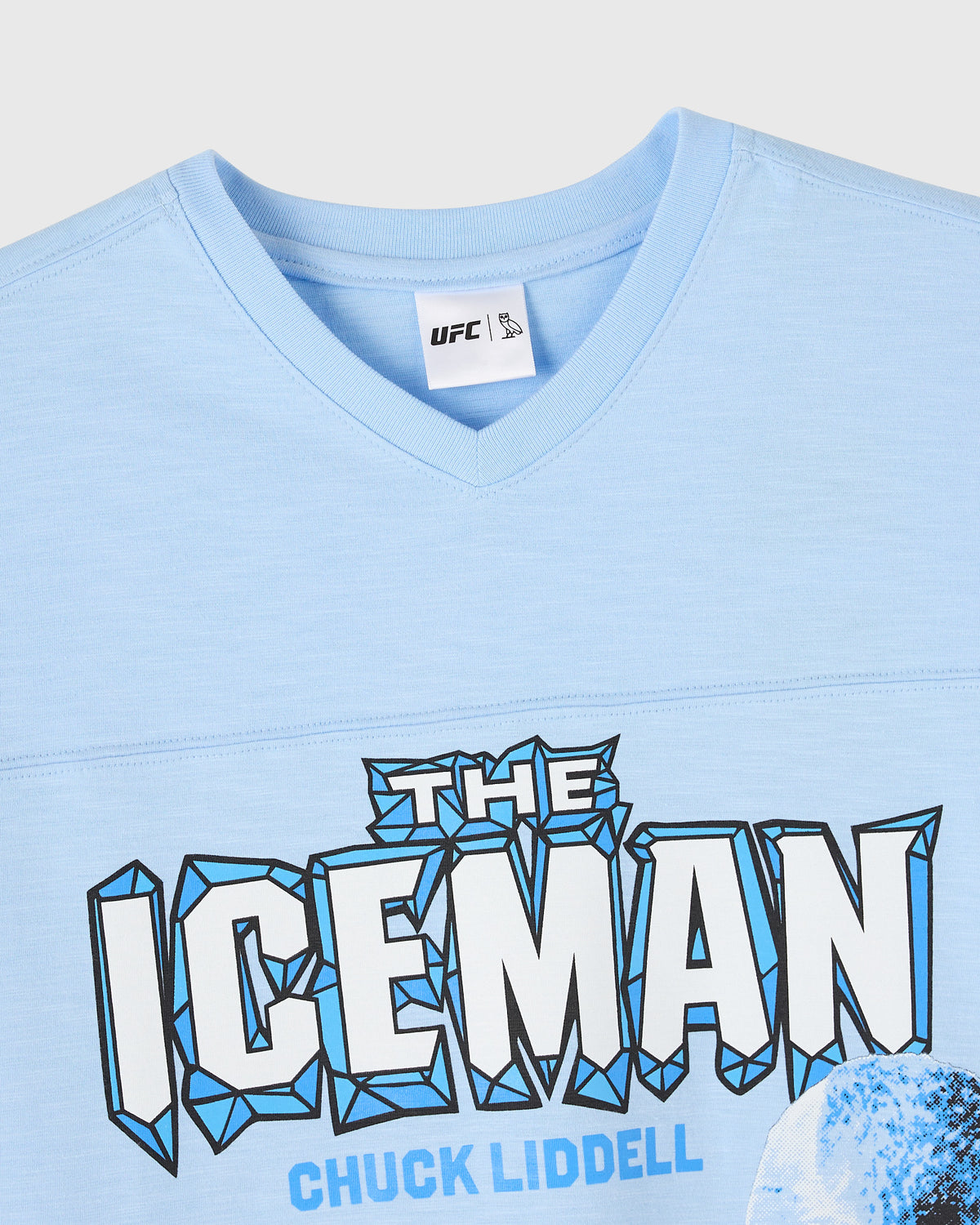 Light blue v-neck tee with "The Iceman" text and Chuck Liddell name printed on front, UFC label at neckline.
