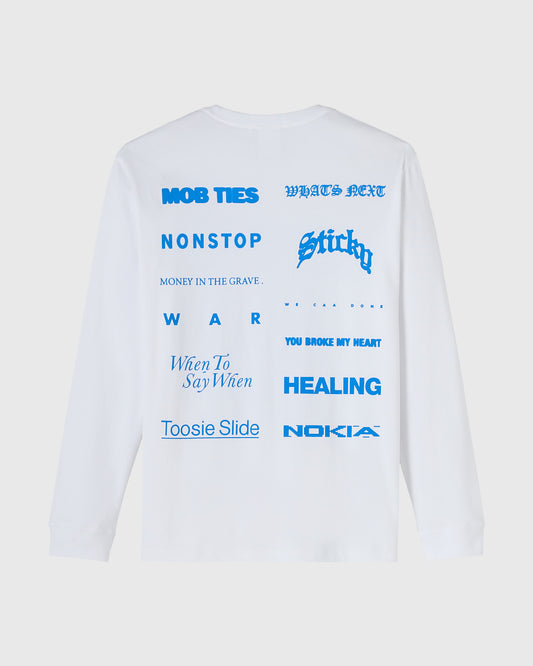 White long-sleeve tee with blue text graphic featuring various song and brand titles arranged across the front.