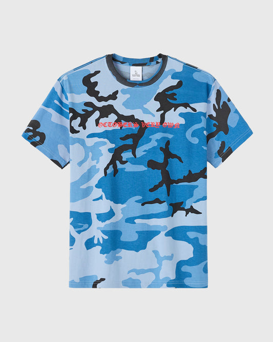 Blue camouflage t-shirt with black and light blue camo pattern and red text on chest.