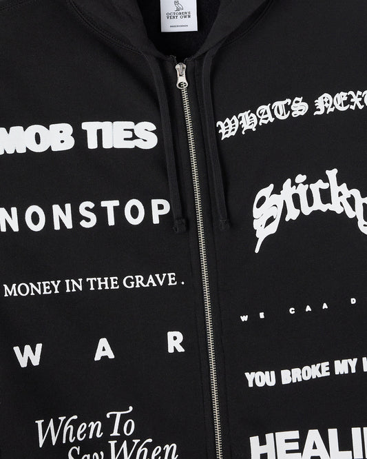 Black zip-hoodie with white text graphics and metal zipper closure.