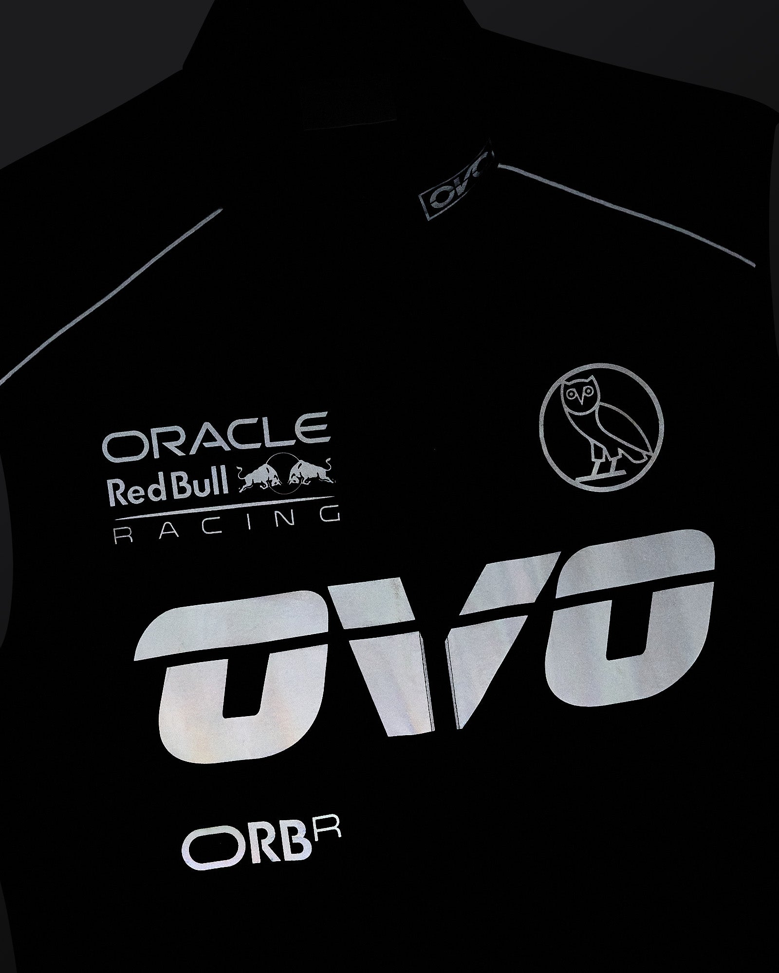 Navy nylon vest with reflective Oracle Red Bull Racing, owl logo, and text prints on front.