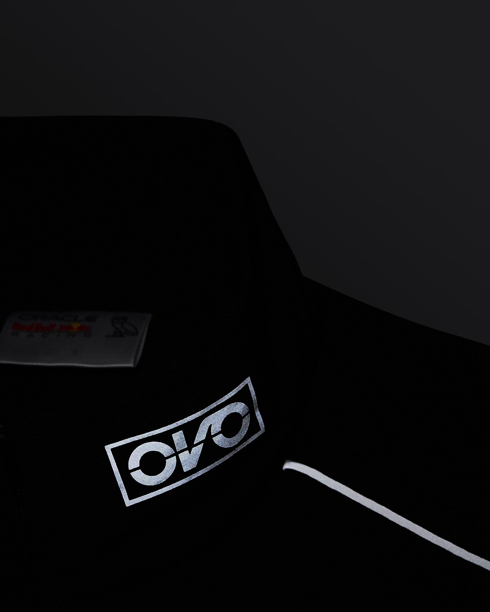 Navy nylon vest with reflective OKO print logo on chest and care label visible.
