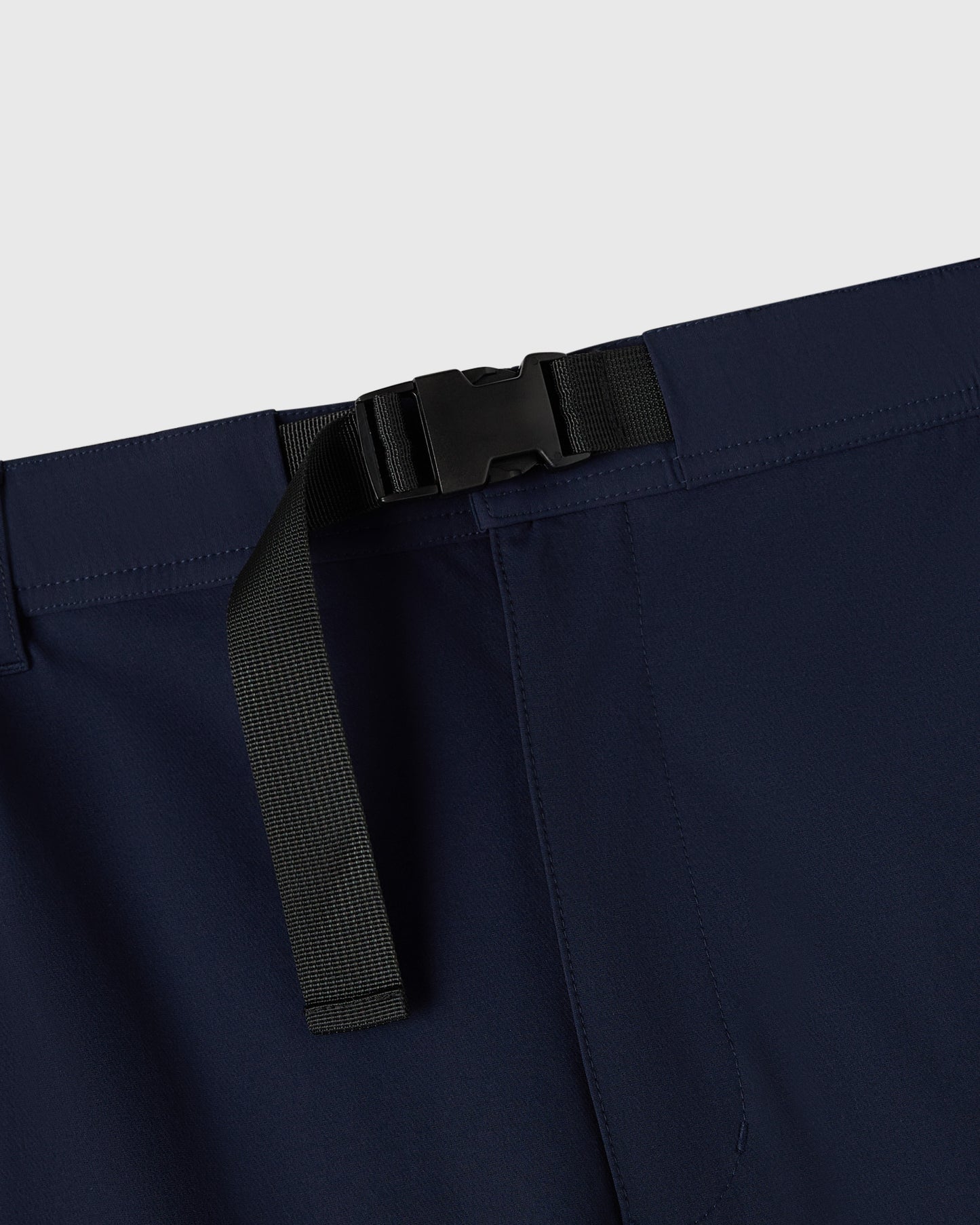 Navy nylon pant with black plastic buckle and reflective stripe detail at waistband.