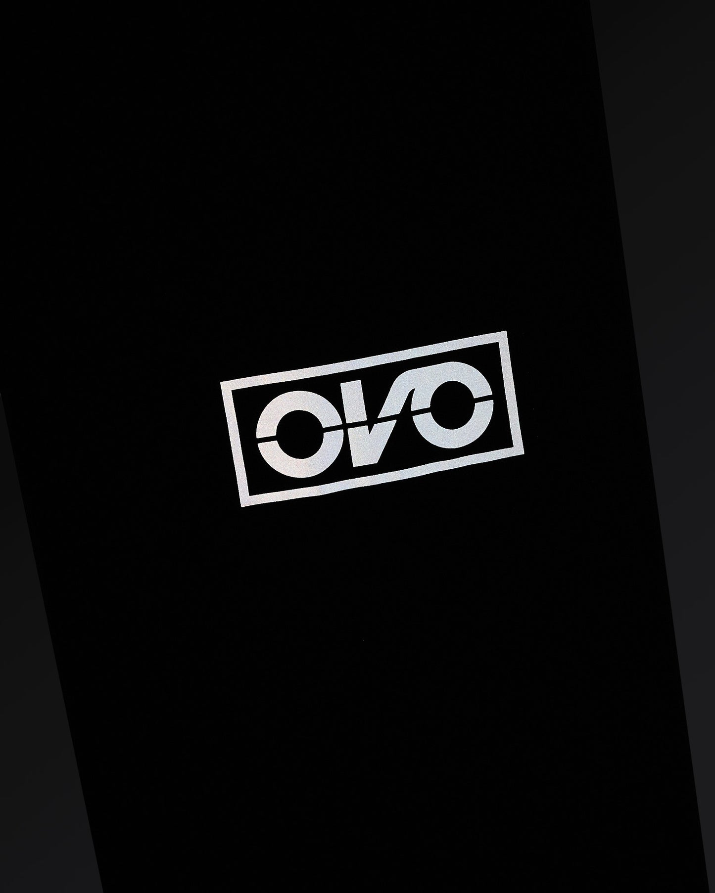 Navy nylon pant with reflective OVO logo print on leg.