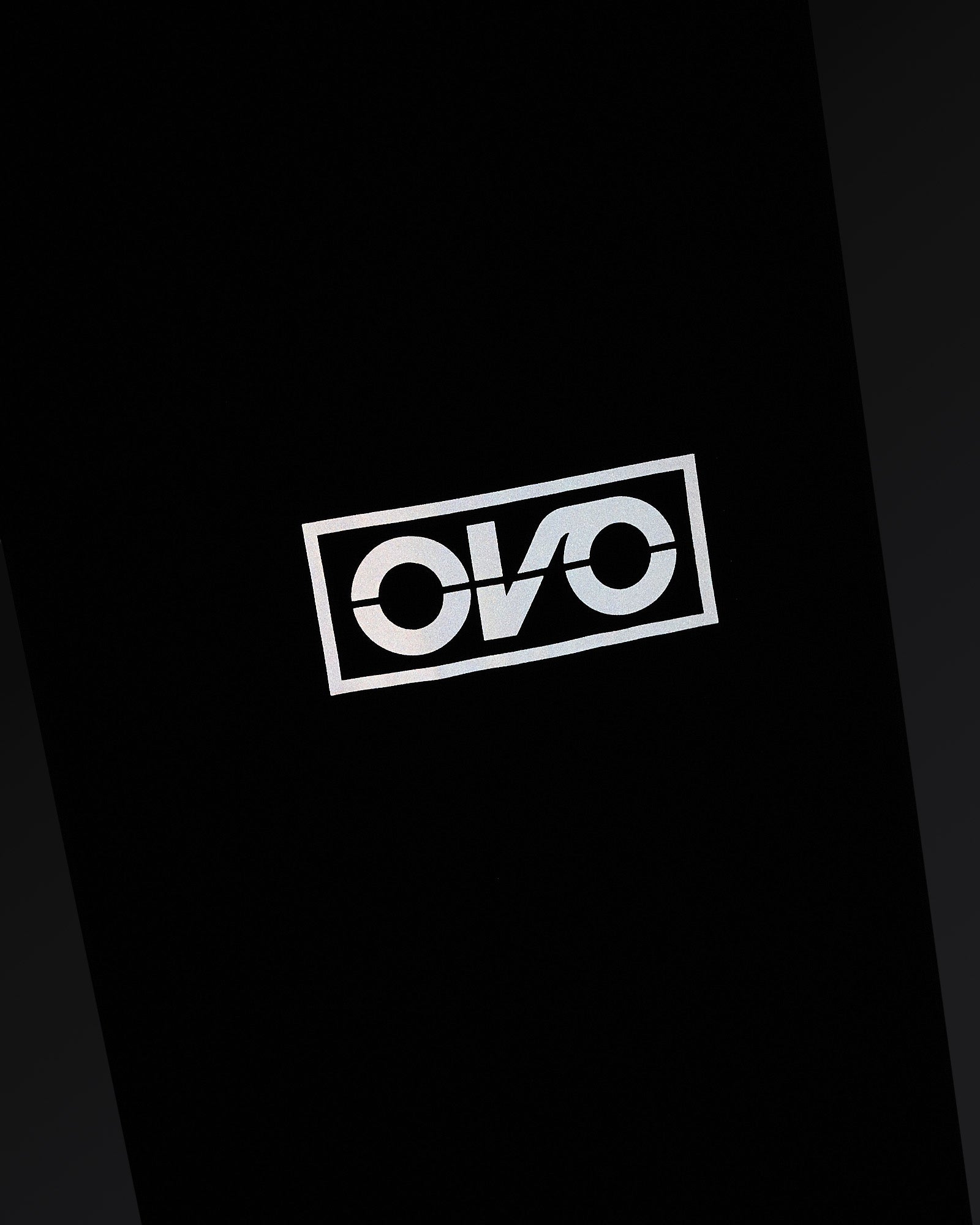 Navy nylon pant with reflective OVO logo print on leg.