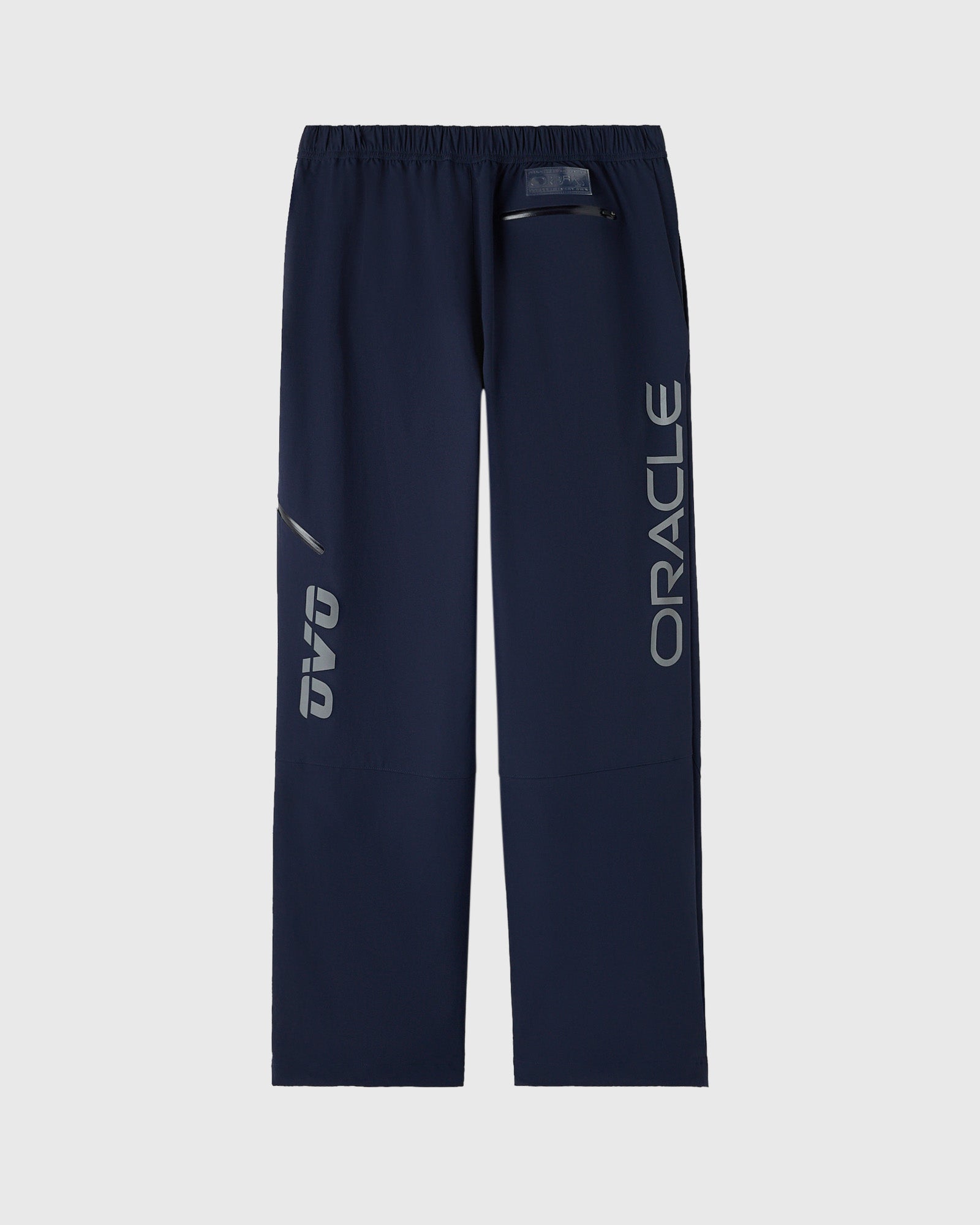 Navy nylon pants with reflective "ORACLE" text down the legs and drawstring waist.