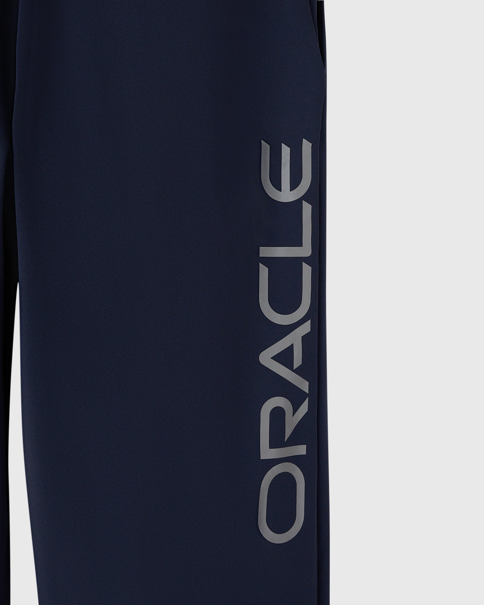 Navy nylon pant with reflective "Oracle" text printed down the leg.