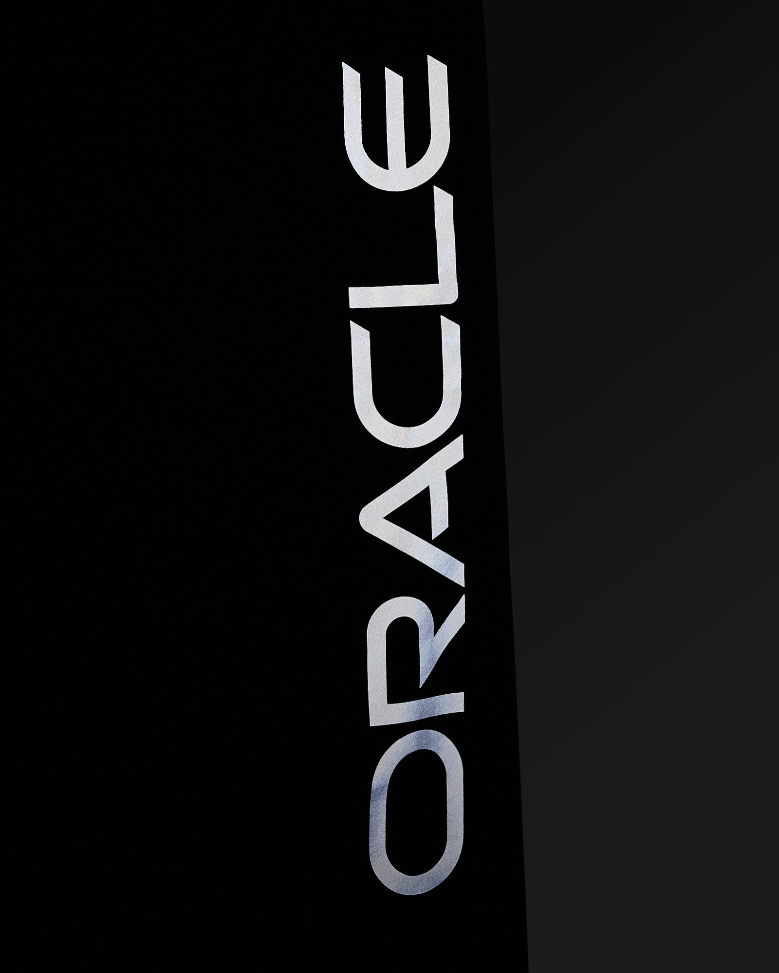 Navy nylon pant with large reflective "Oracle Red Bull" text printed vertically down the leg.