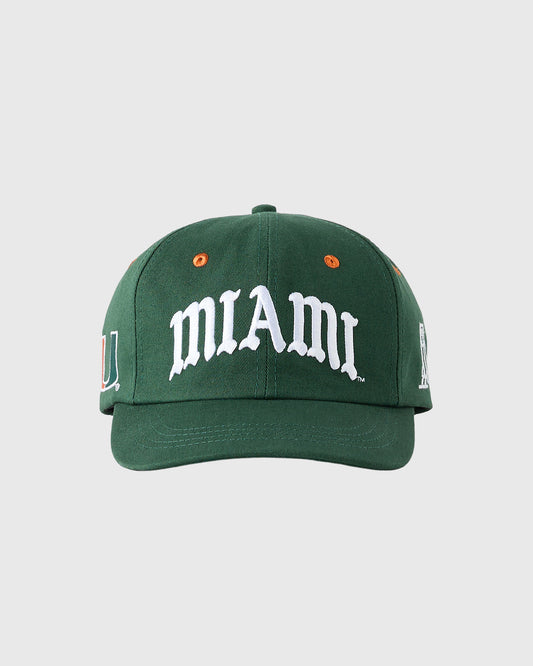 Green baseball cap with white "MIAMI" text, orange eyelets, and side logo embroidery.