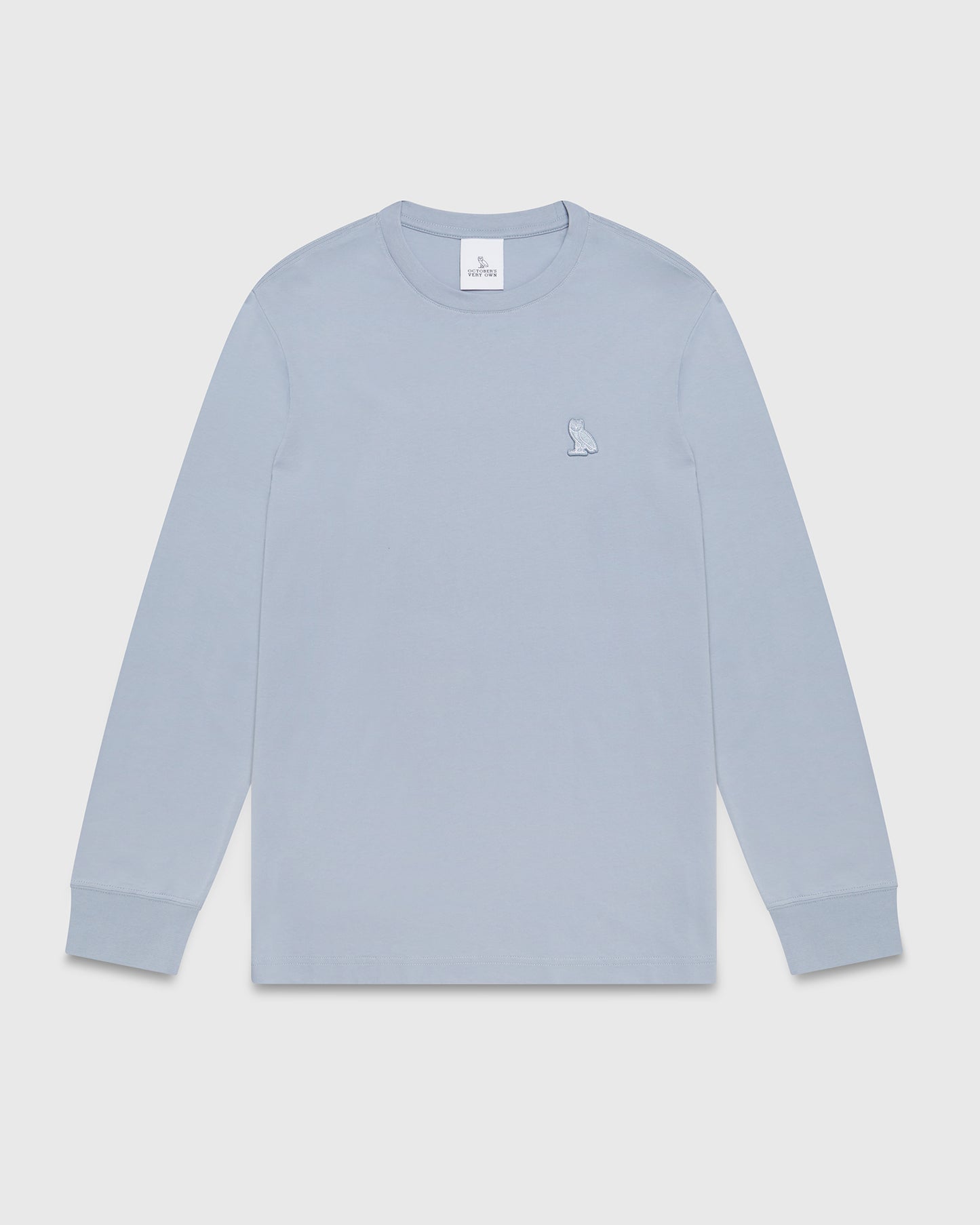 Light blue long-sleeve t-shirt with small owl embroidery on chest and ribbed cuffs.