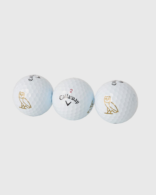 Three white Callaway Chrome Soft golf balls with gold owl logos and Callaway branding displayed against a gray background.