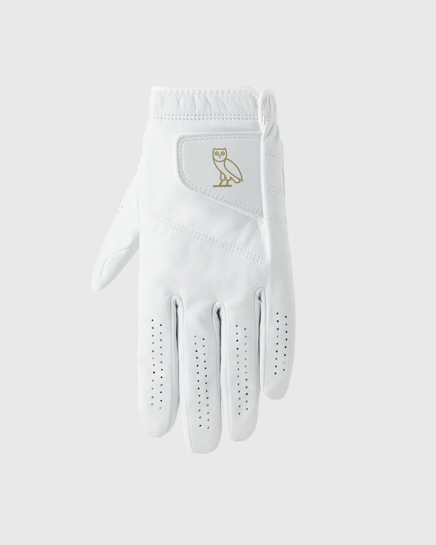 White golf glove with gold owl logo on back and perforated grip pattern on palm and fingers.