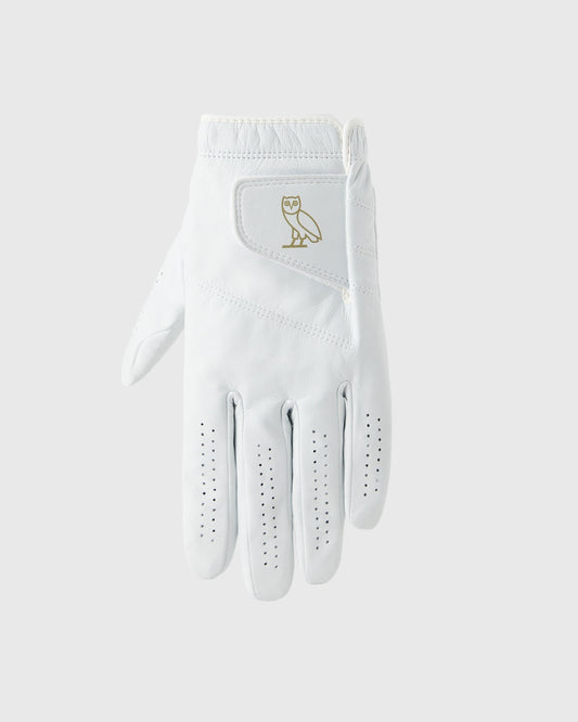 White golf glove with gold owl logo on back and perforated grip pattern on palm and fingers.