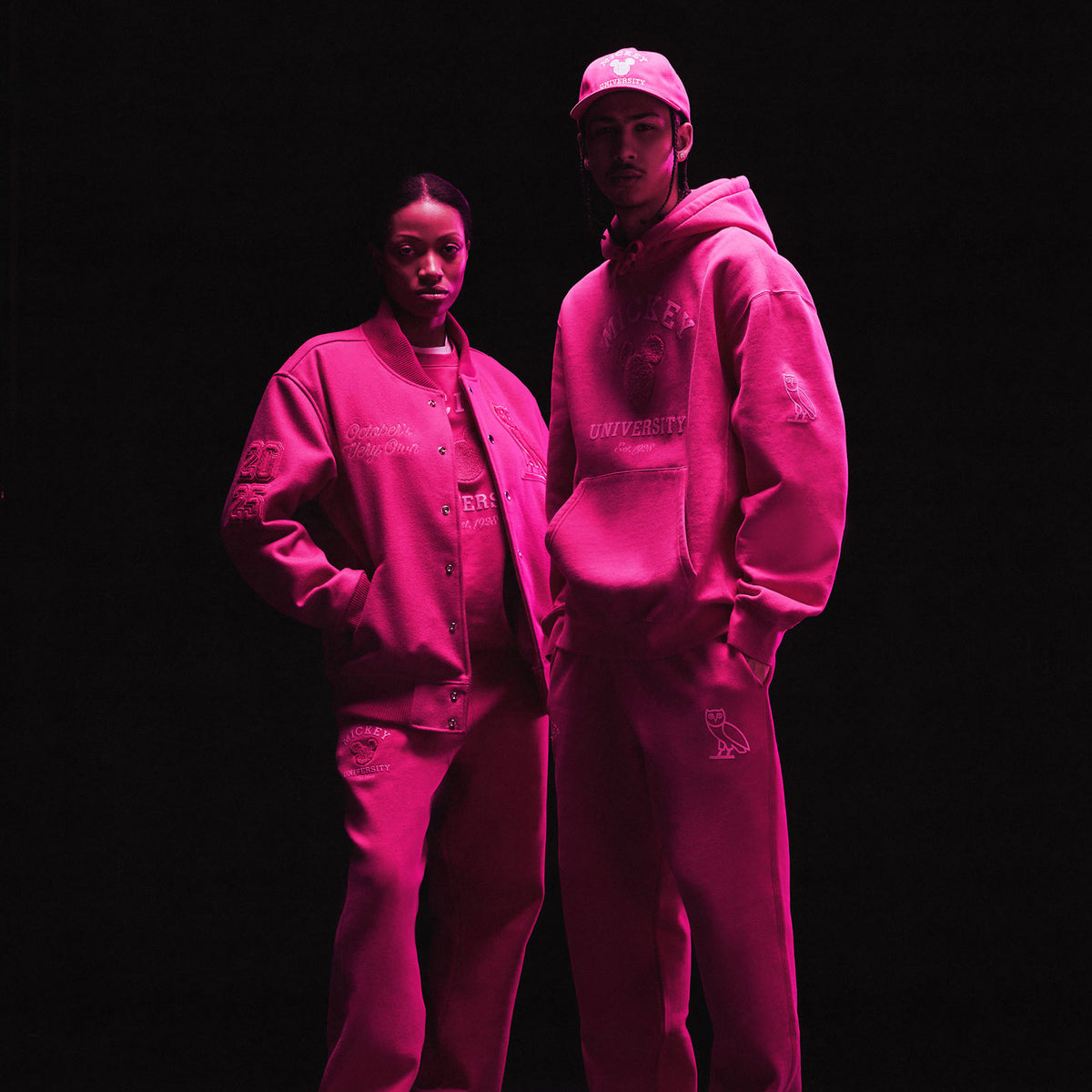 two people wearing the October's Very Own x Disney collection sweatsuits