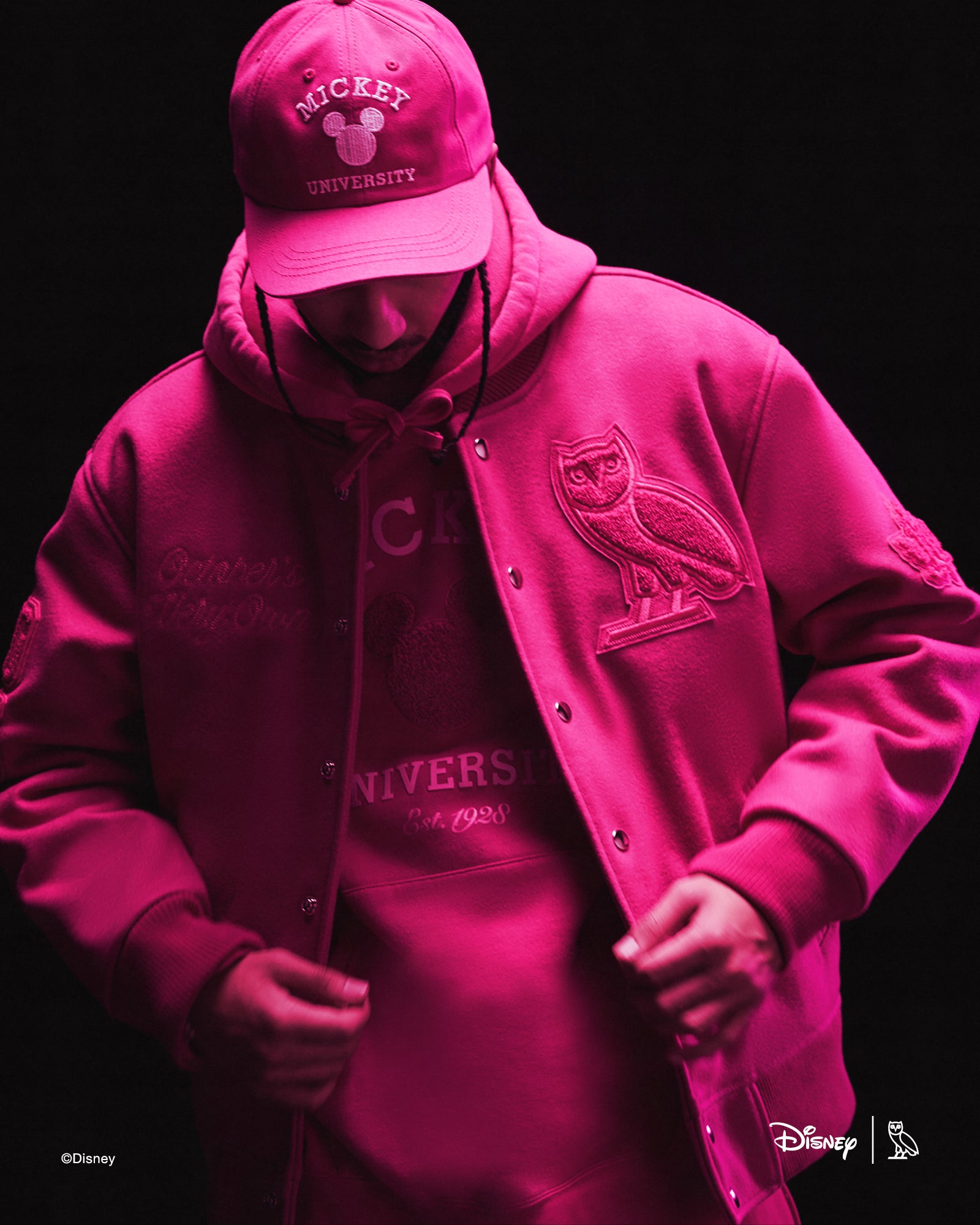Person wearing pink October's Very Own x Disney outfits with a dark background