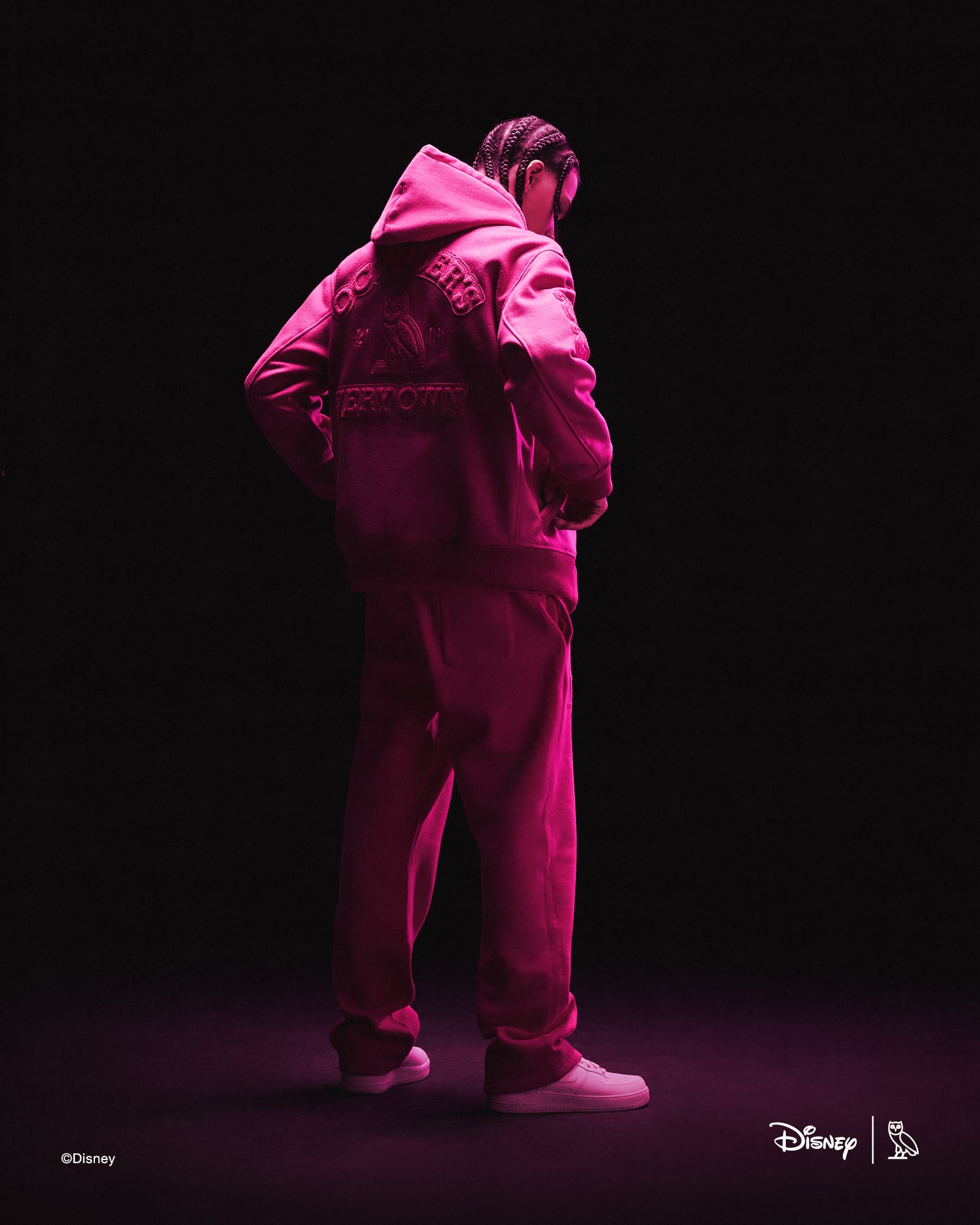 Person wearing pink October's Very Own x Disney outfits with a dark background