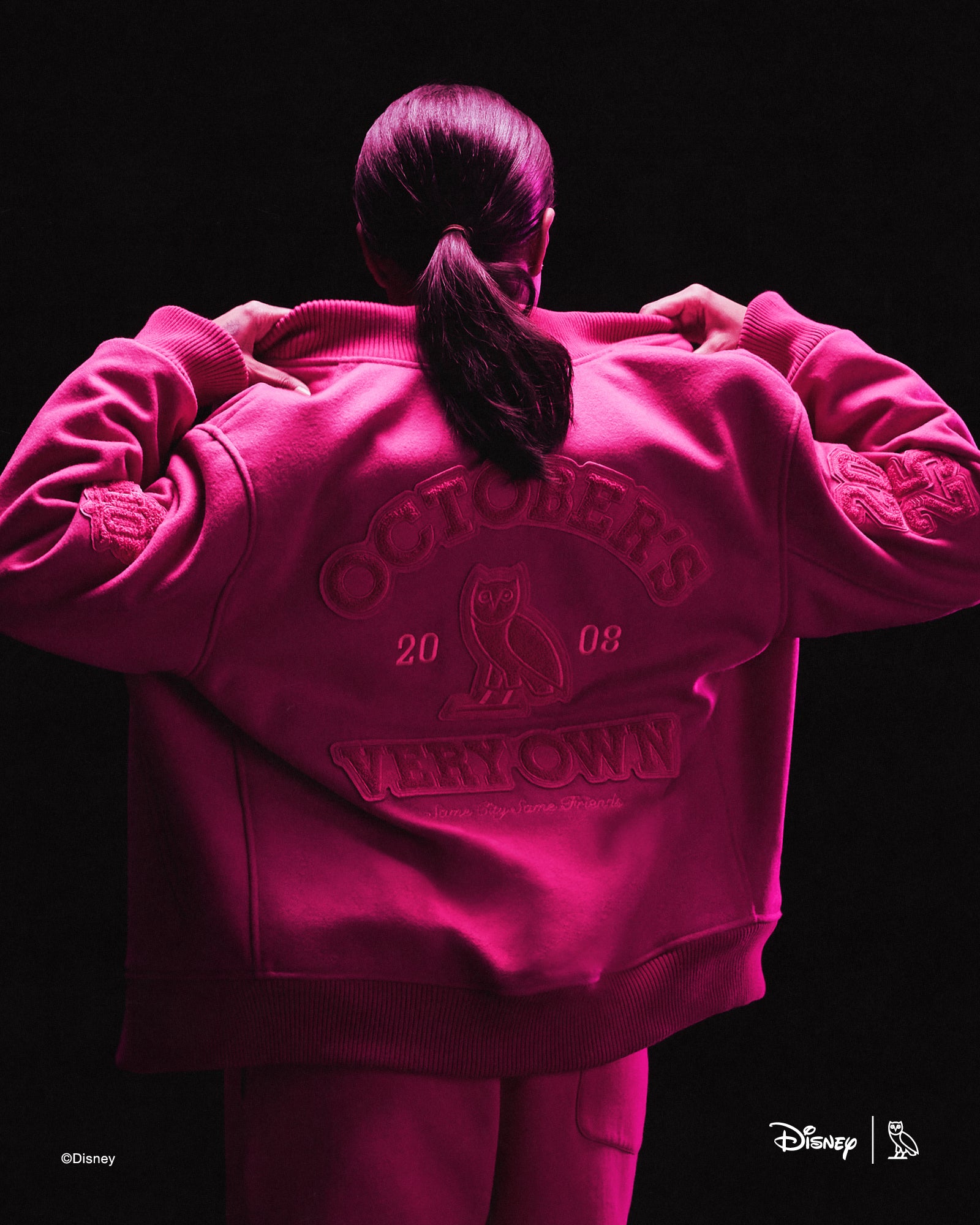 Person wearing pink October's Very Own x Disney outfits with a dark background