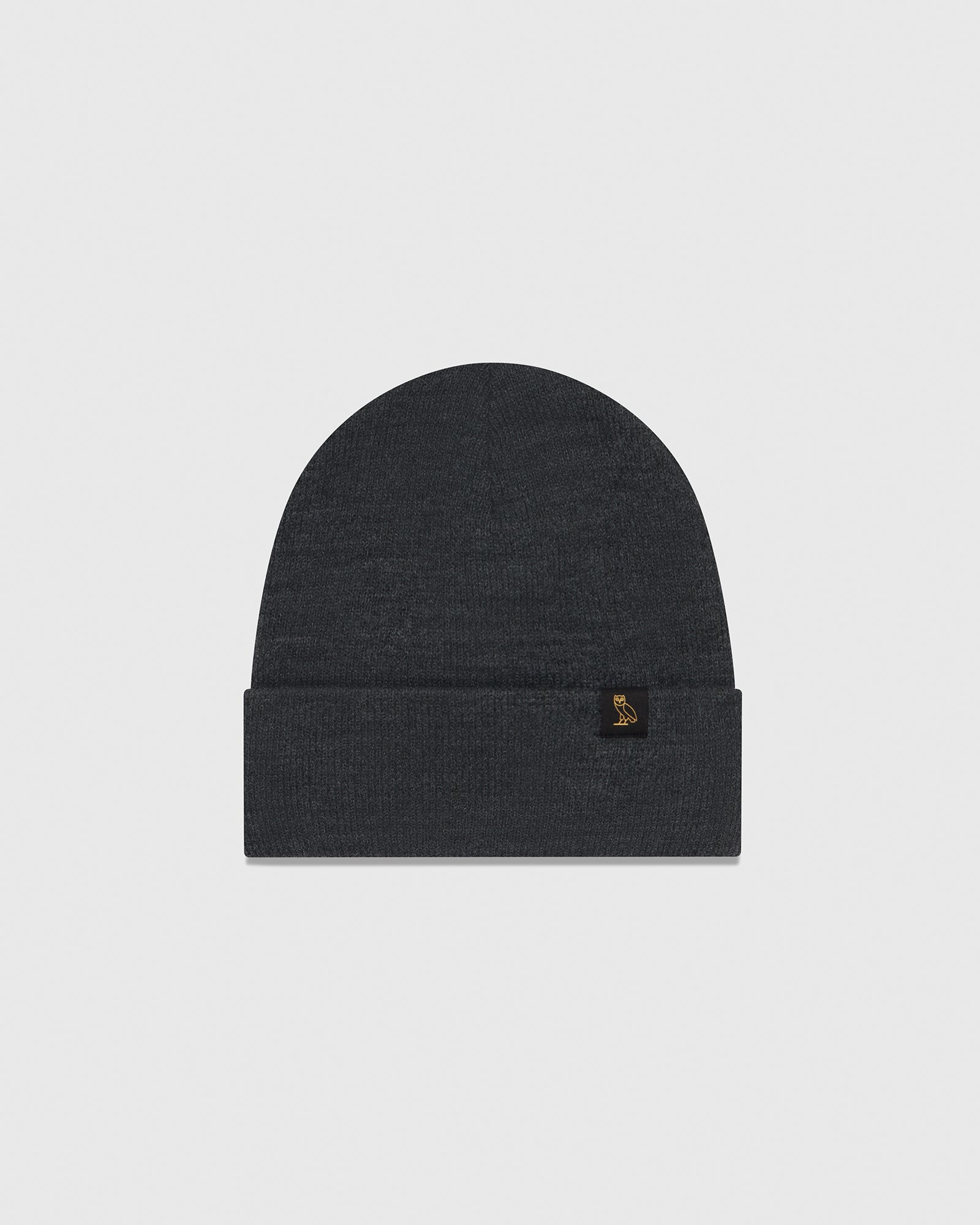 Dark grey knit beanie with folded cuff and small embroidered logo on front.