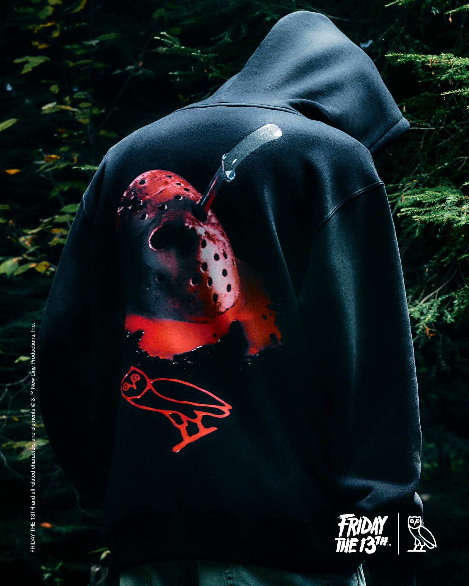 Person wearing a October's Very Own hoodie with 'Friday the 13th' design, dark background