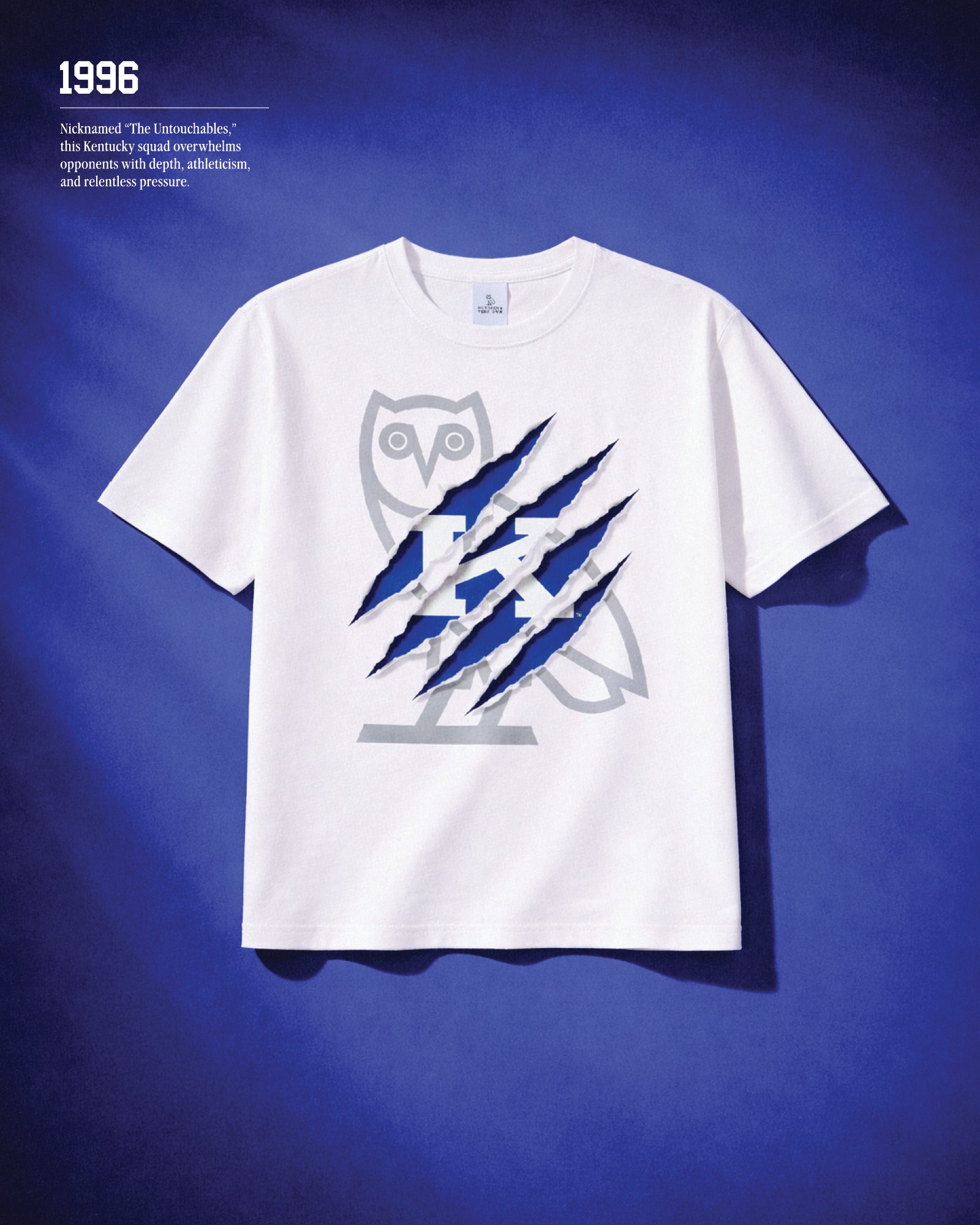 1996. Nicknamed "the Untouchables" this Kentucky squad overwhelms opponents with depth, athleticism, and relentless pressureWhite t-shirt with blue and gray graphic design on a blue background