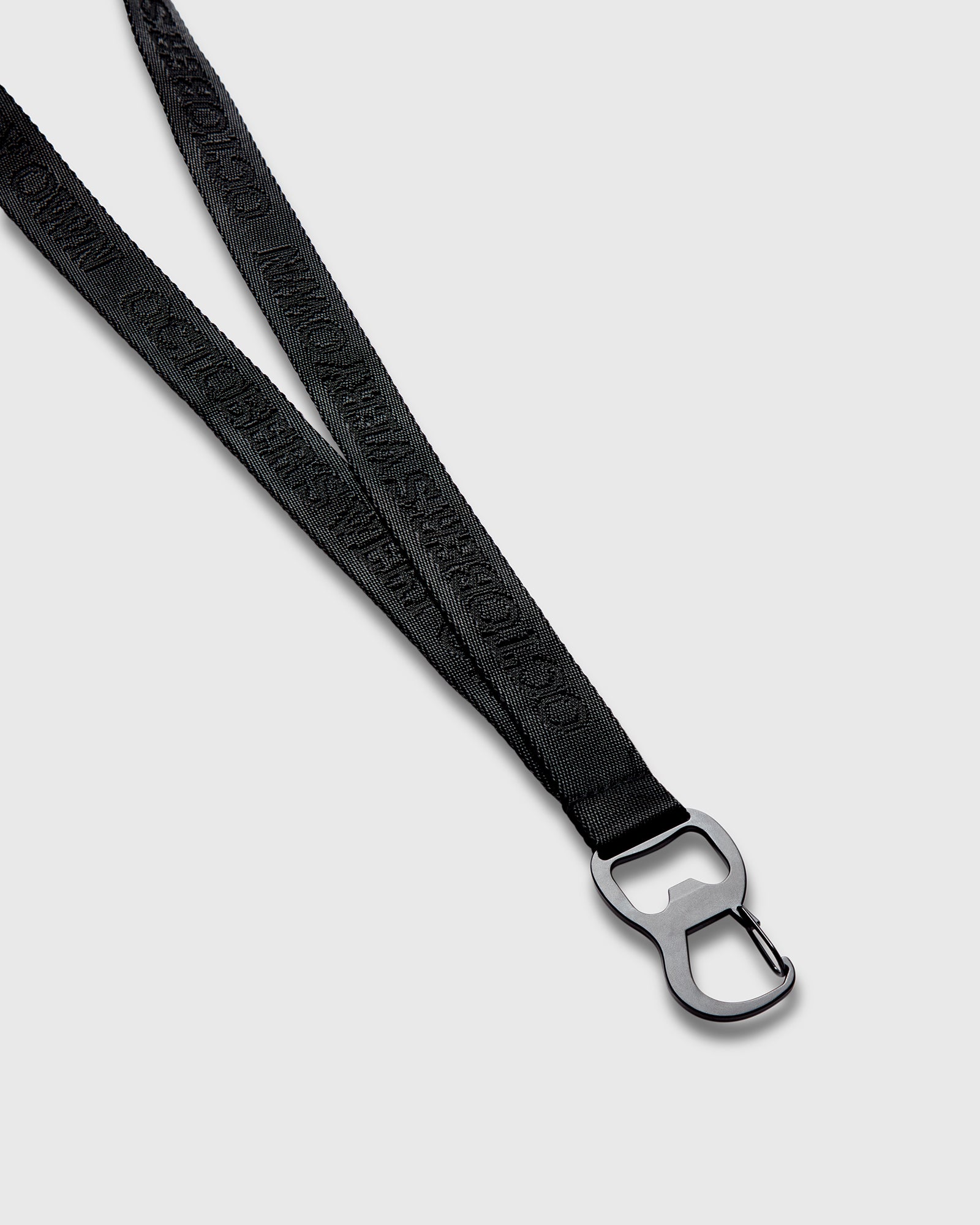 Black lanyard with woven texture and metal clip attachment at end.