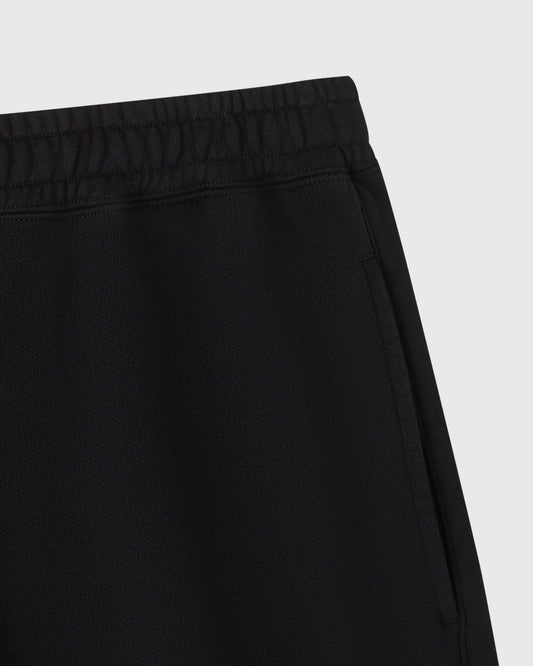 Black sweatshort with elastic waistband and ribbed texture detail.