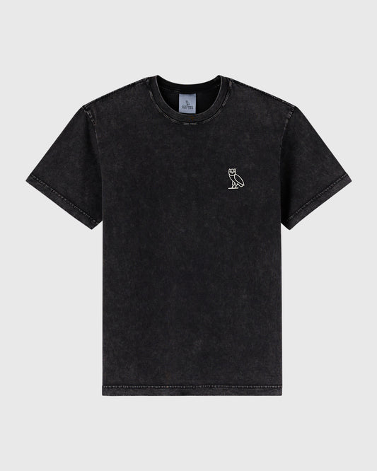 Black garment dyed t-shirt with small owl emblem on chest and distressed edges throughout.