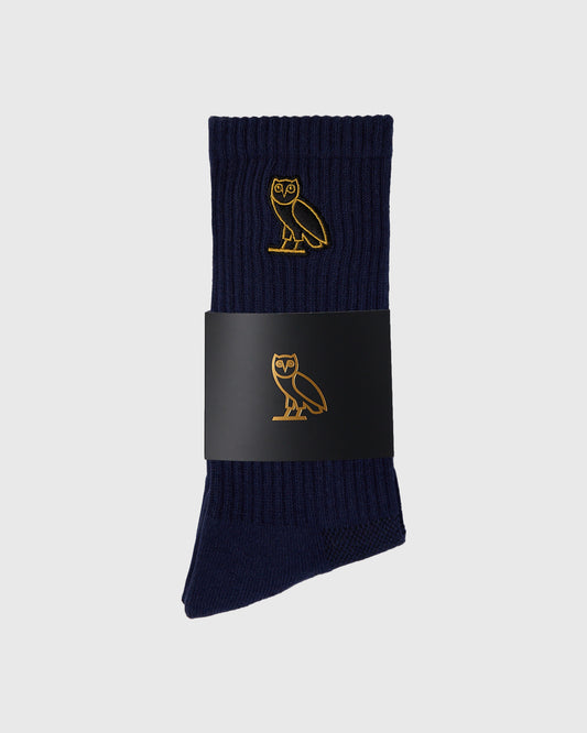 Navy ribbed socks with gold owl embroidery, displayed with black band wrapper.