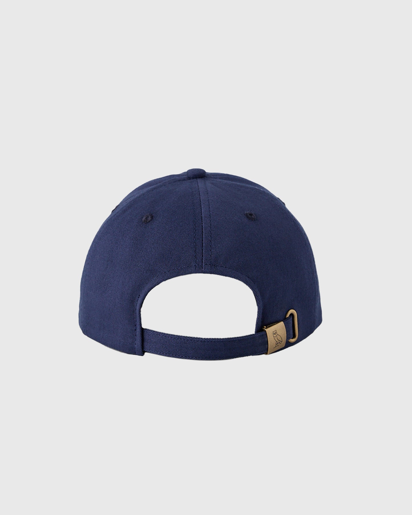 Navy baseball cap with six-panel crown, front stitching detail, and metal buckle back closure.