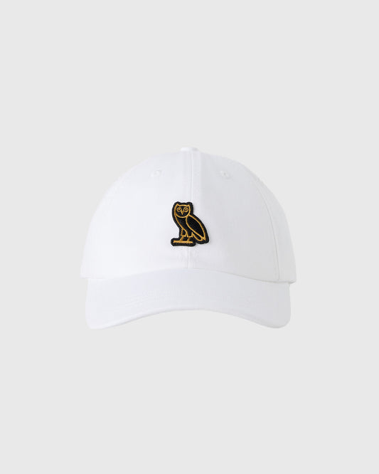 White baseball cap with gold and black owl emblem on front.
