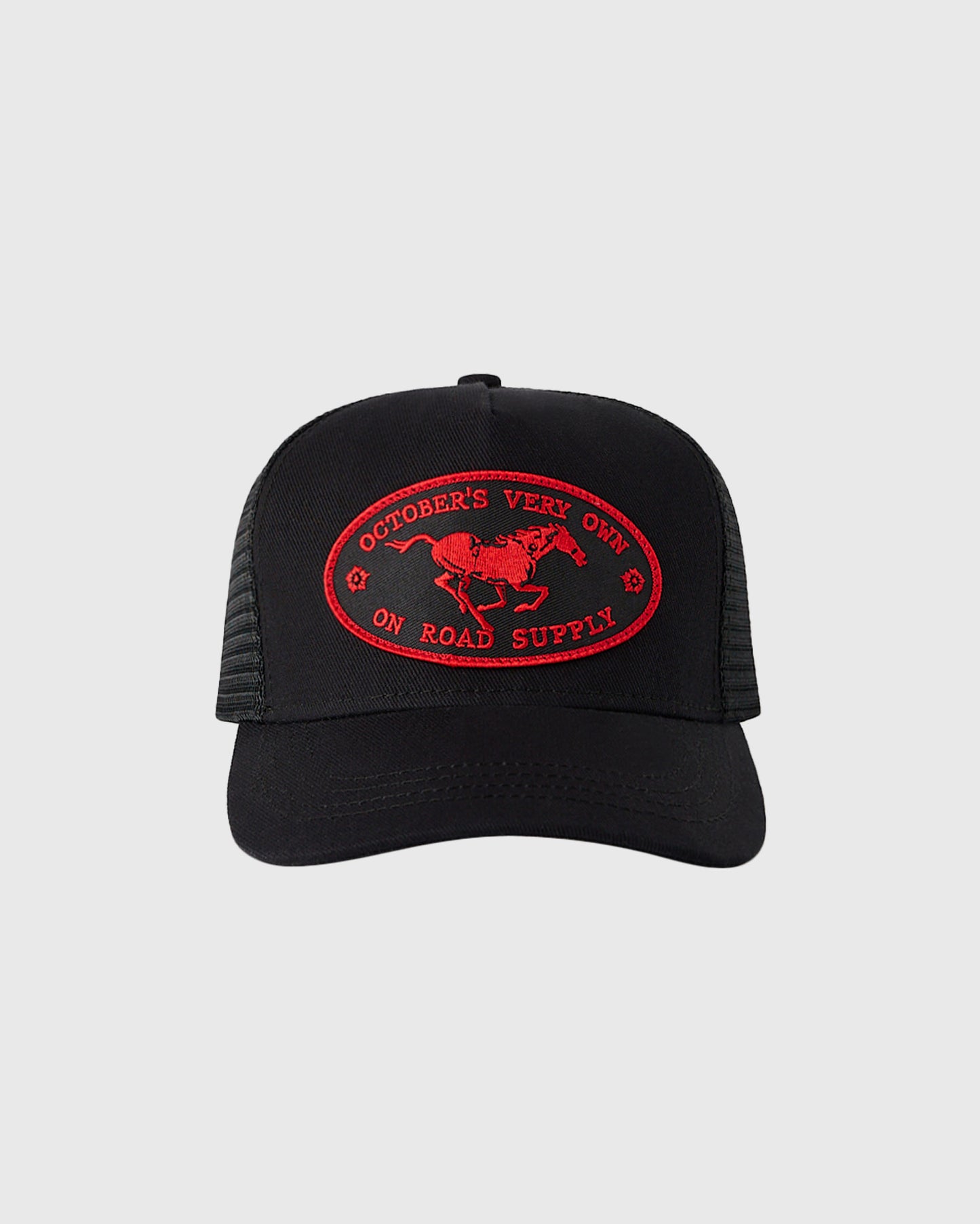 Black trucker hat with red embroidered oval patch featuring horse and "October's Vert On Road Supply" text.
