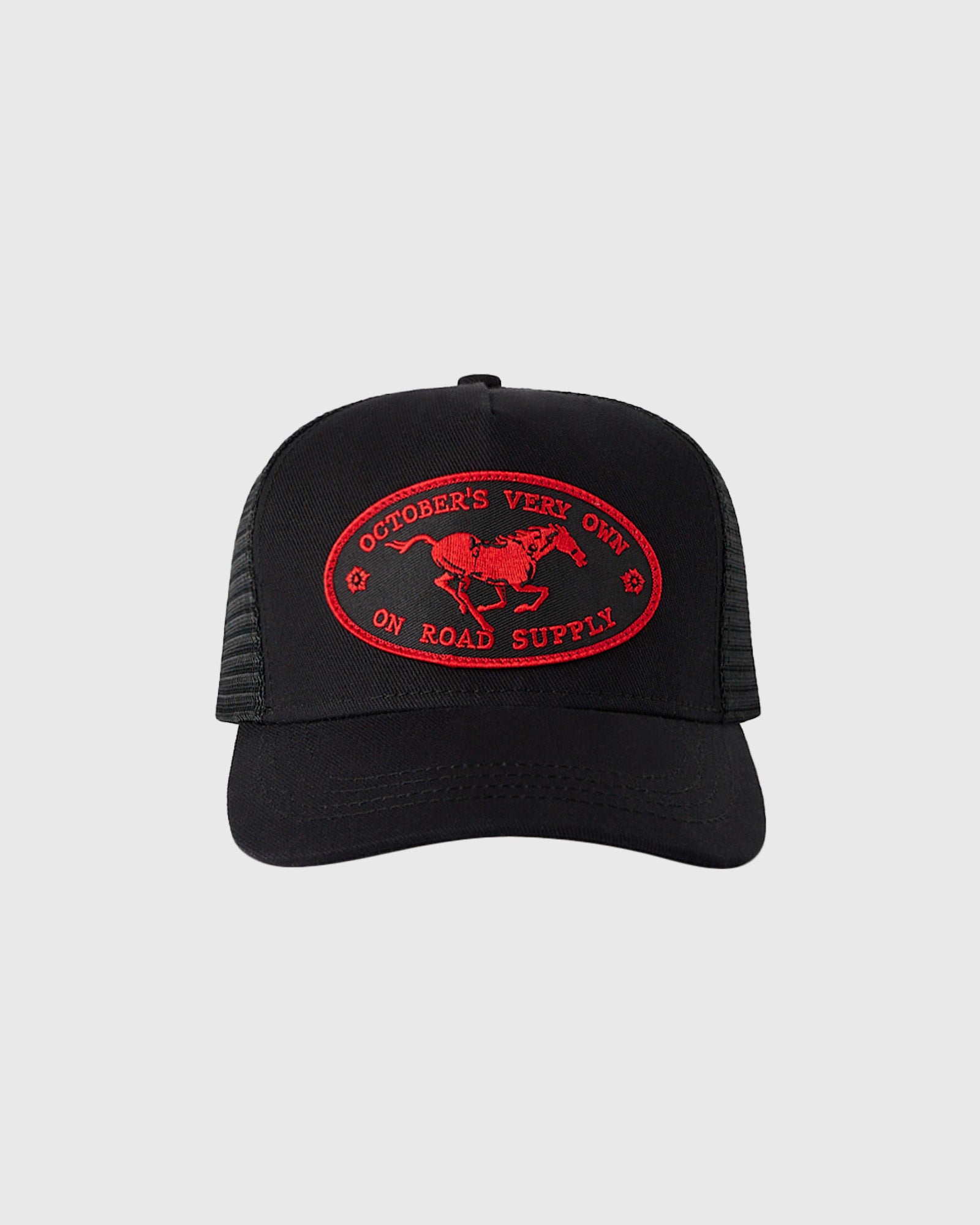 Black trucker hat with red embroidered oval patch featuring horse and "October's Vert On Road Supply" text.
