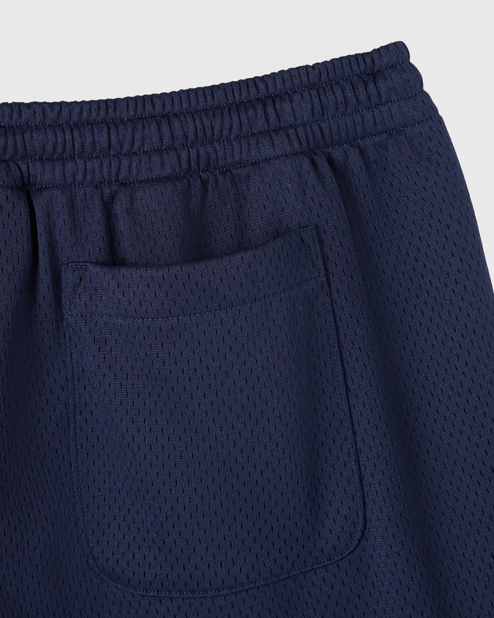Navy mesh shorts with elasticated waistband and front pocket detail.