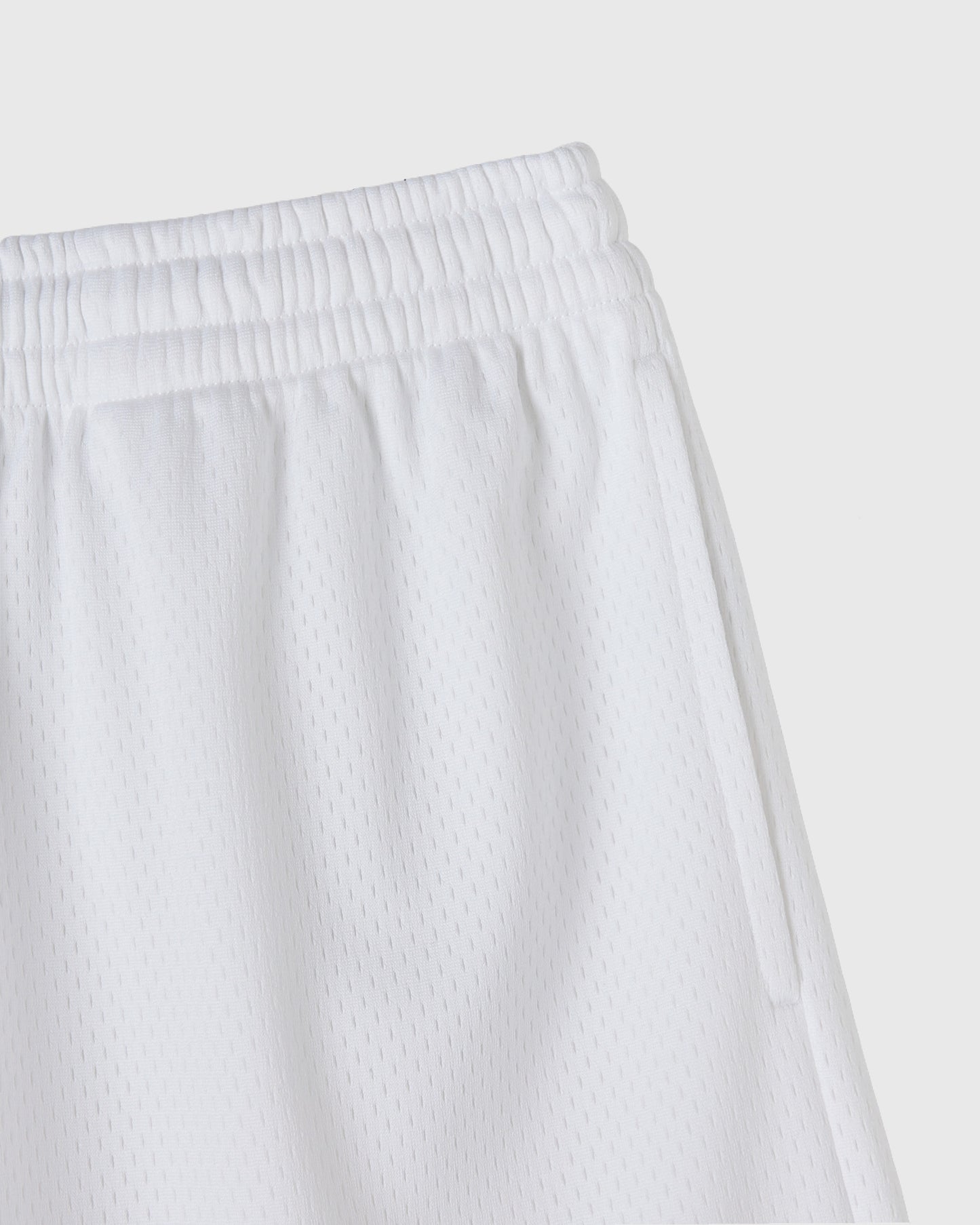 White mesh shorts with elastic waistband and textured fabric detail.