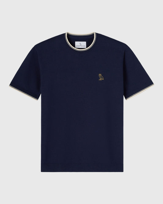 Navy short-sleeve sweater t-shirt with cream tipping on collar and cuffs, small owl emblem on chest.