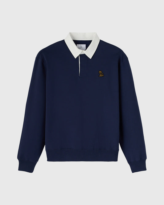 Navy rugby polo with white collar and half-zip front, small embroidered logo on chest.