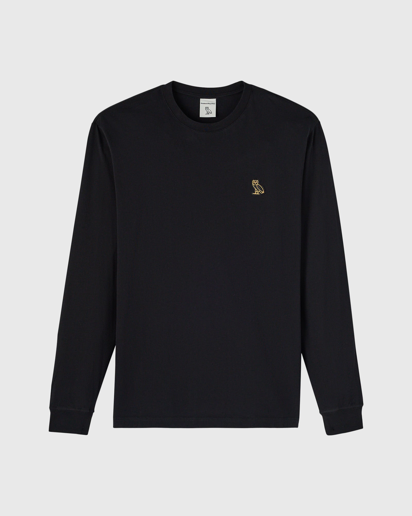 Black long-sleeve crewneck tee with small gold owl embroidered on chest.